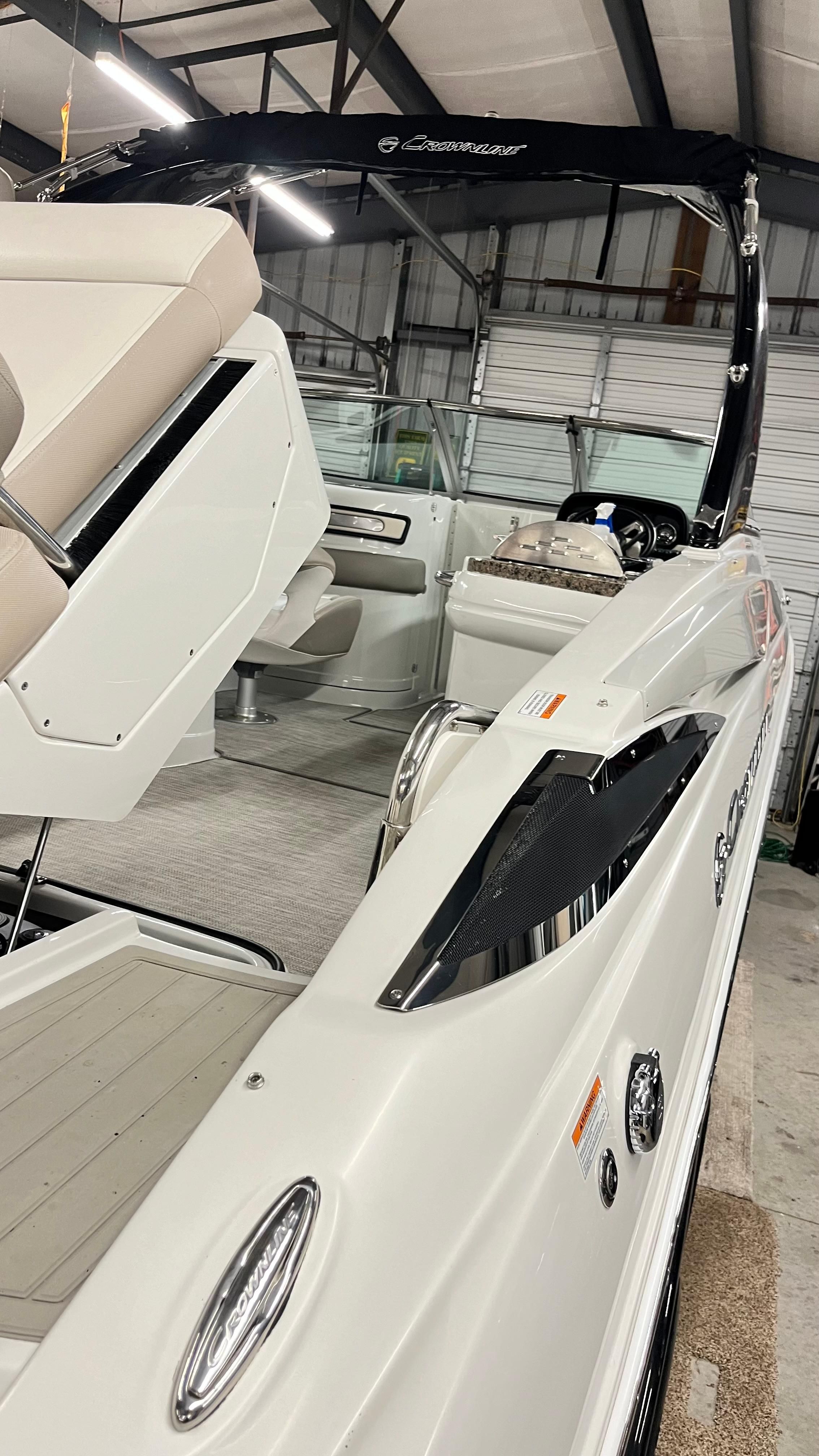 Interior view of a 2019 Crownline E 285 boat in a storage facility.