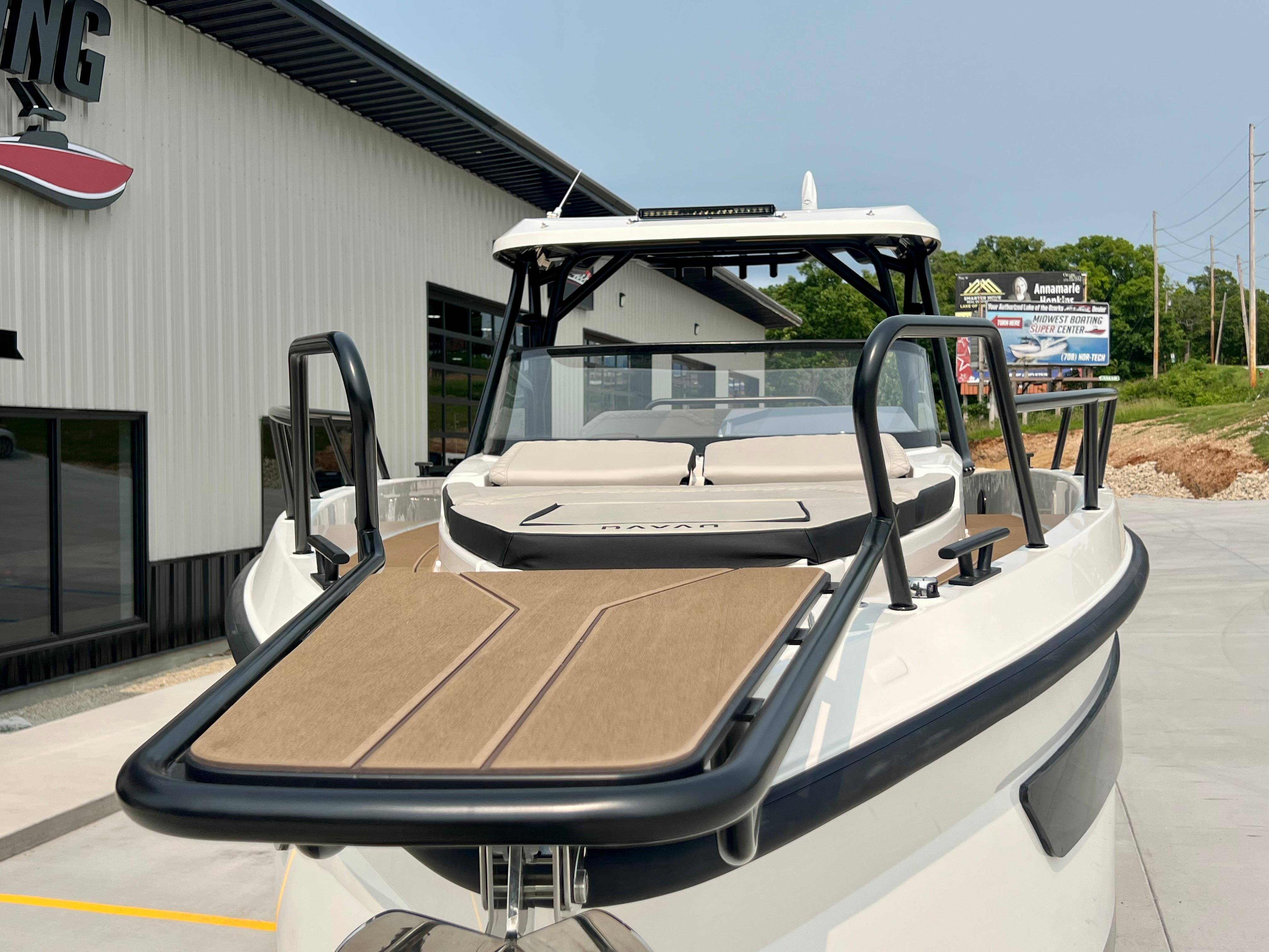 2025 Navan S-30 boat with sleek design, docked near a modern building.
