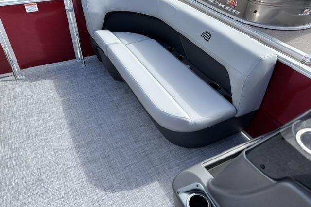 2026 Sun Tracker Party Barge 16 DLX interior with gray seating and red accents.