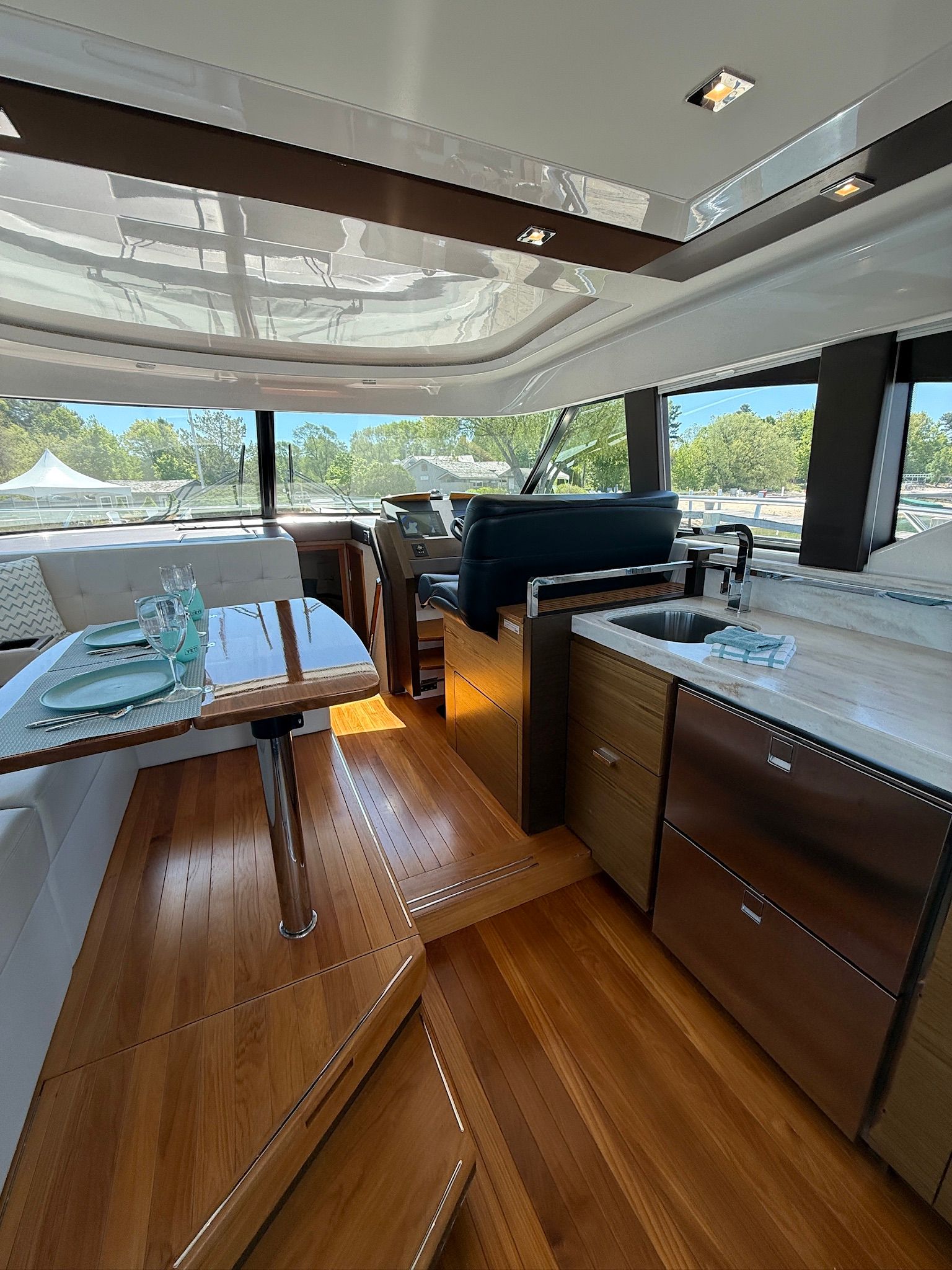 Interior of a 2017 Tiara Yachts C44 Coupe with sleek wood flooring and modern furnishings.