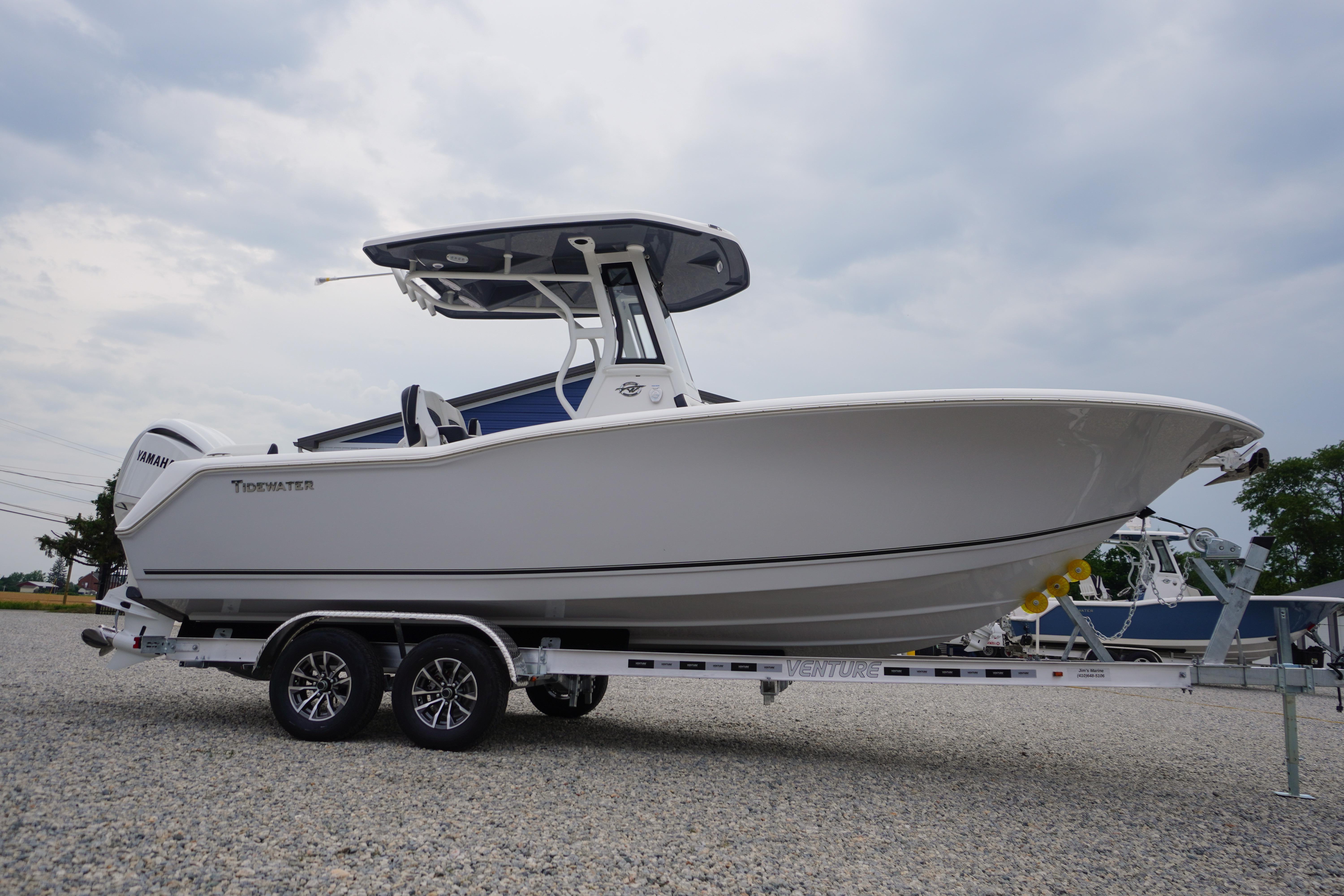 2026 Tidewater 232 SS boat on trailer, displayed outdoors under cloudy sky.