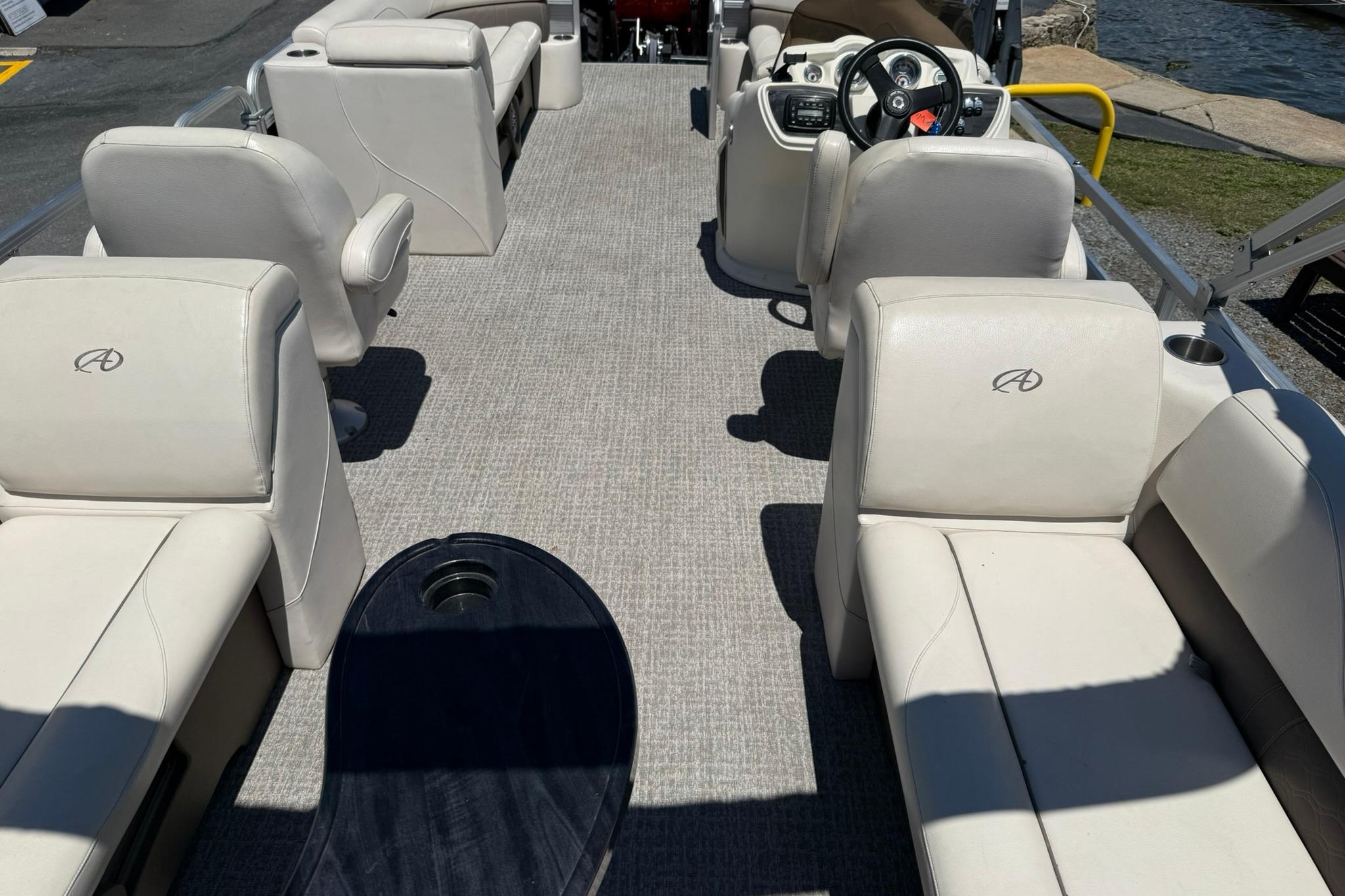 2019 Avalon GS Quad Lounge 25' boat interior with plush seating and steering console.