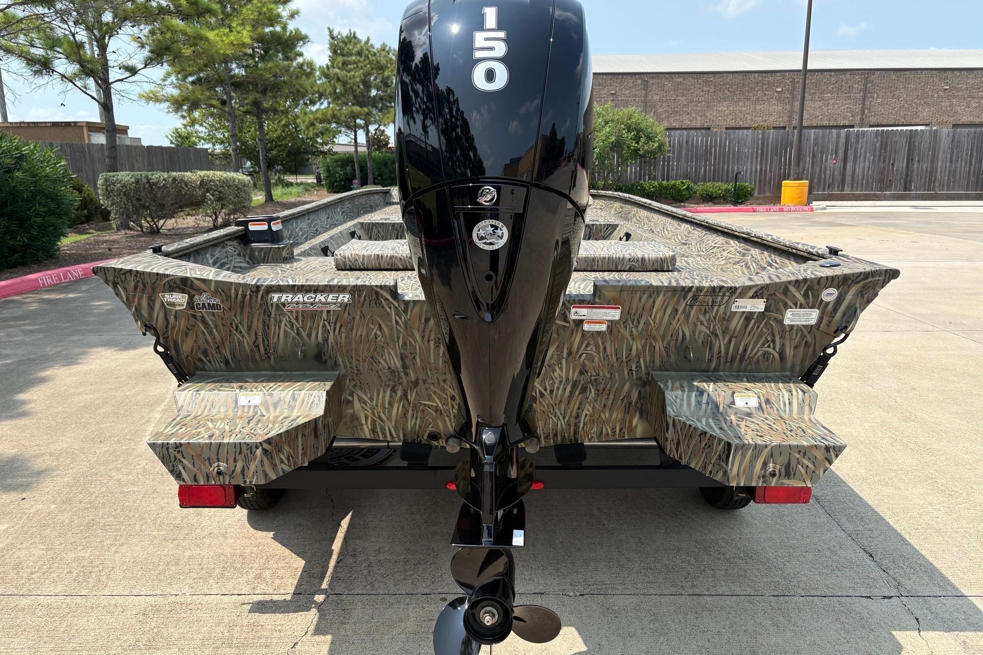 2026 Tracker Grizzly 2072 CC boat with camouflage design and 150 HP outboard motor.