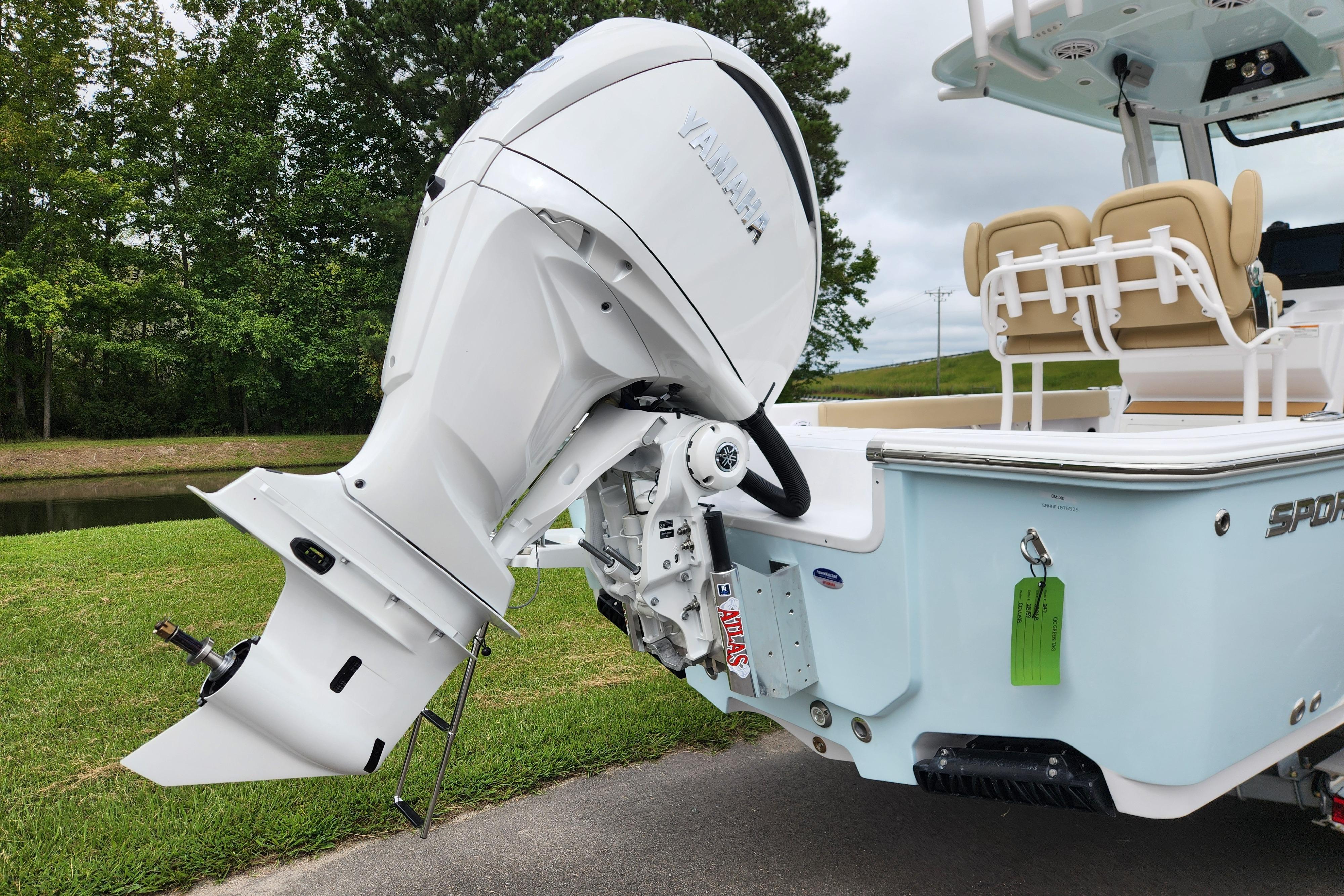 2026 Sportsman Masters 247 Bay Boat with Yamaha outboard engine, parked on grass.