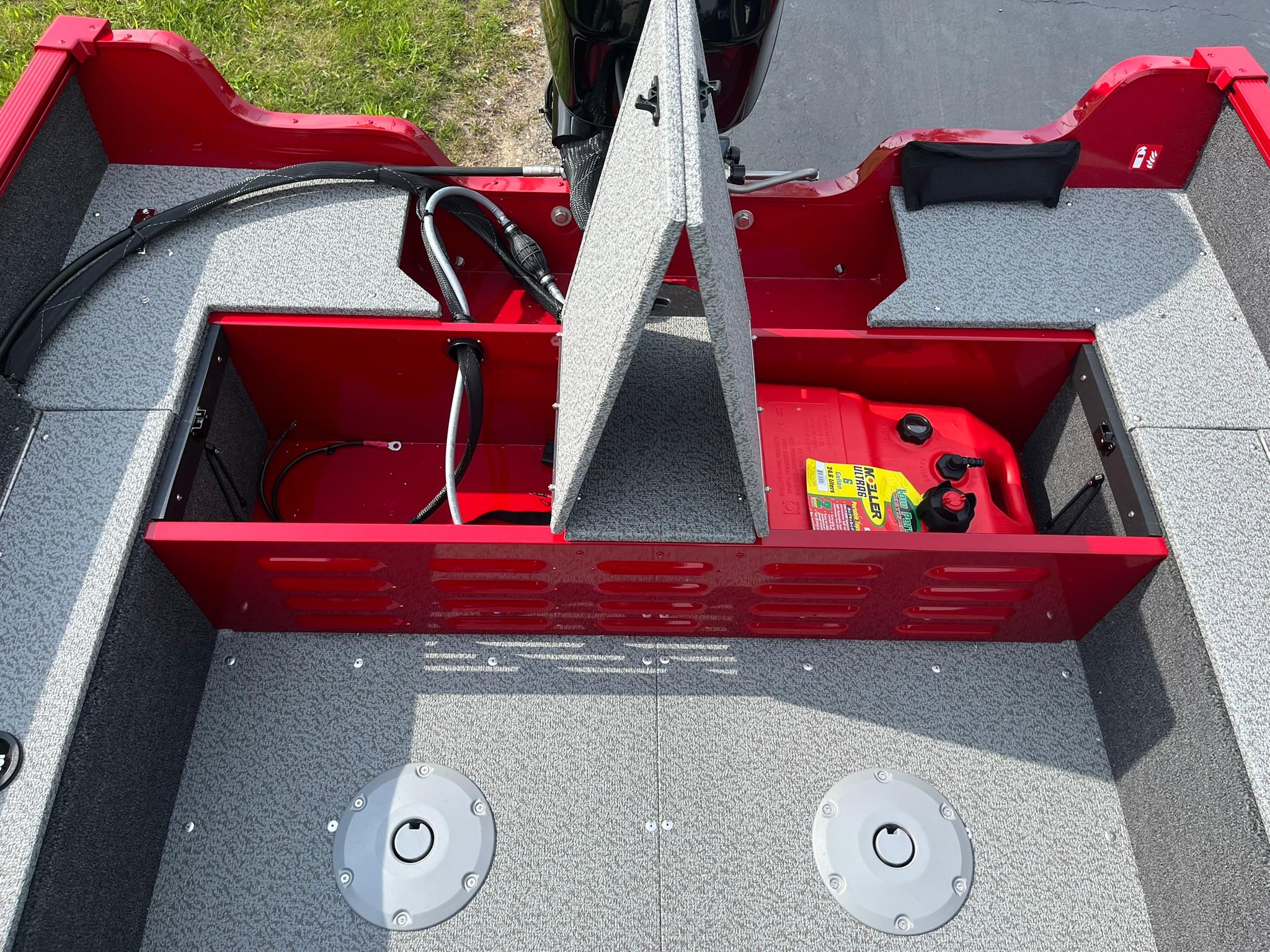 2026 Lund 1650 Angler SS boat interior with open storage compartments and fuel tank.
