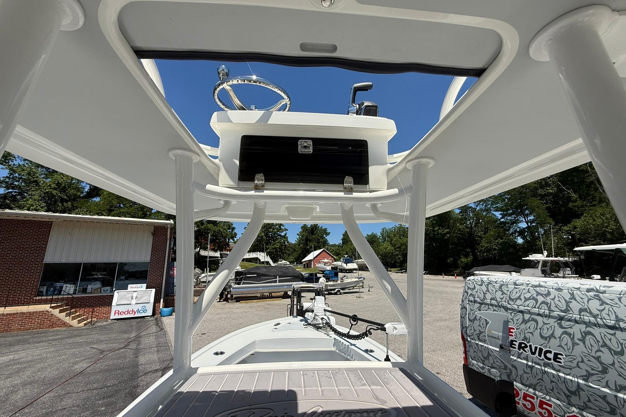 2024 Pair Customs 24 Center Console MV boat, showcasing helm and deck area in a marina setting.