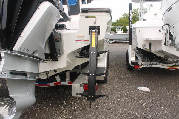 2024 Fountain 34 SC boat with outboard motor and trailer, rear view.