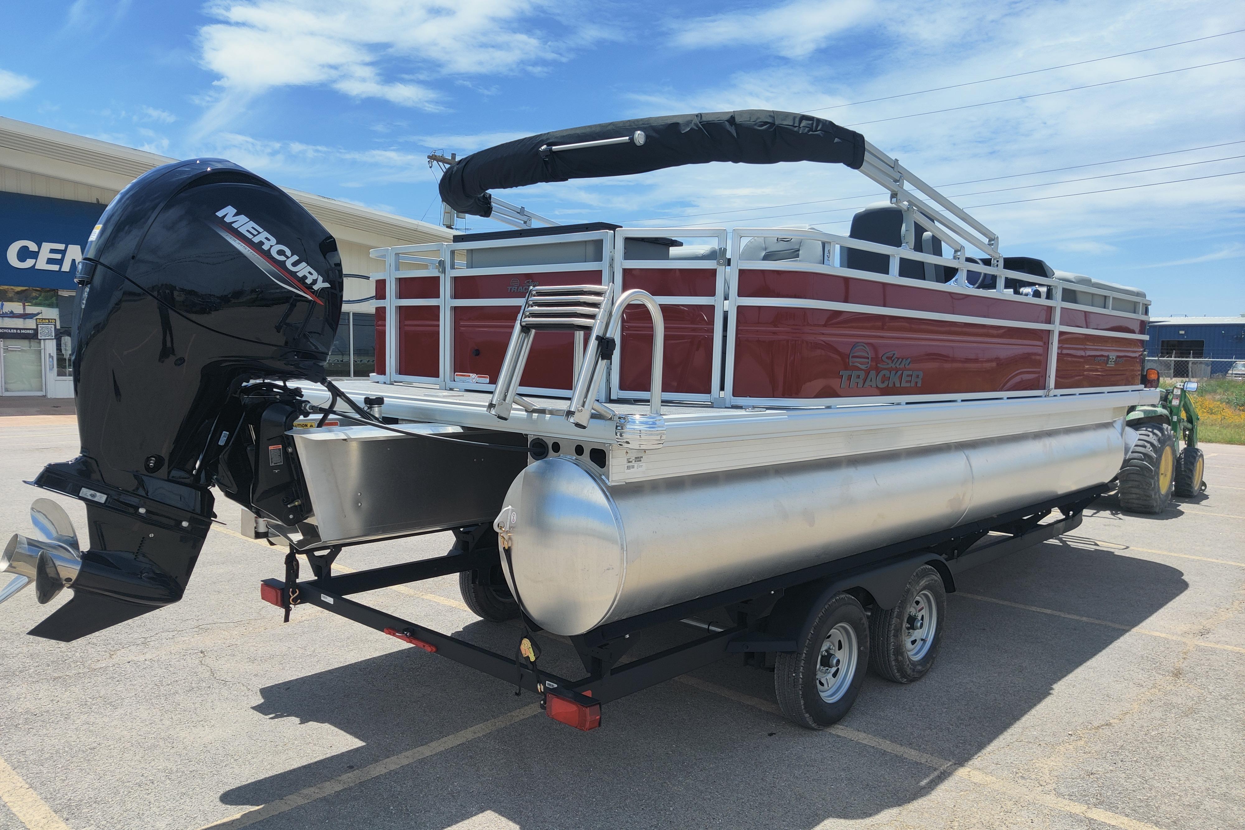 2026 Sun Tracker SportFish 22 DLX pontoon boat with Mercury engine on trailer.
