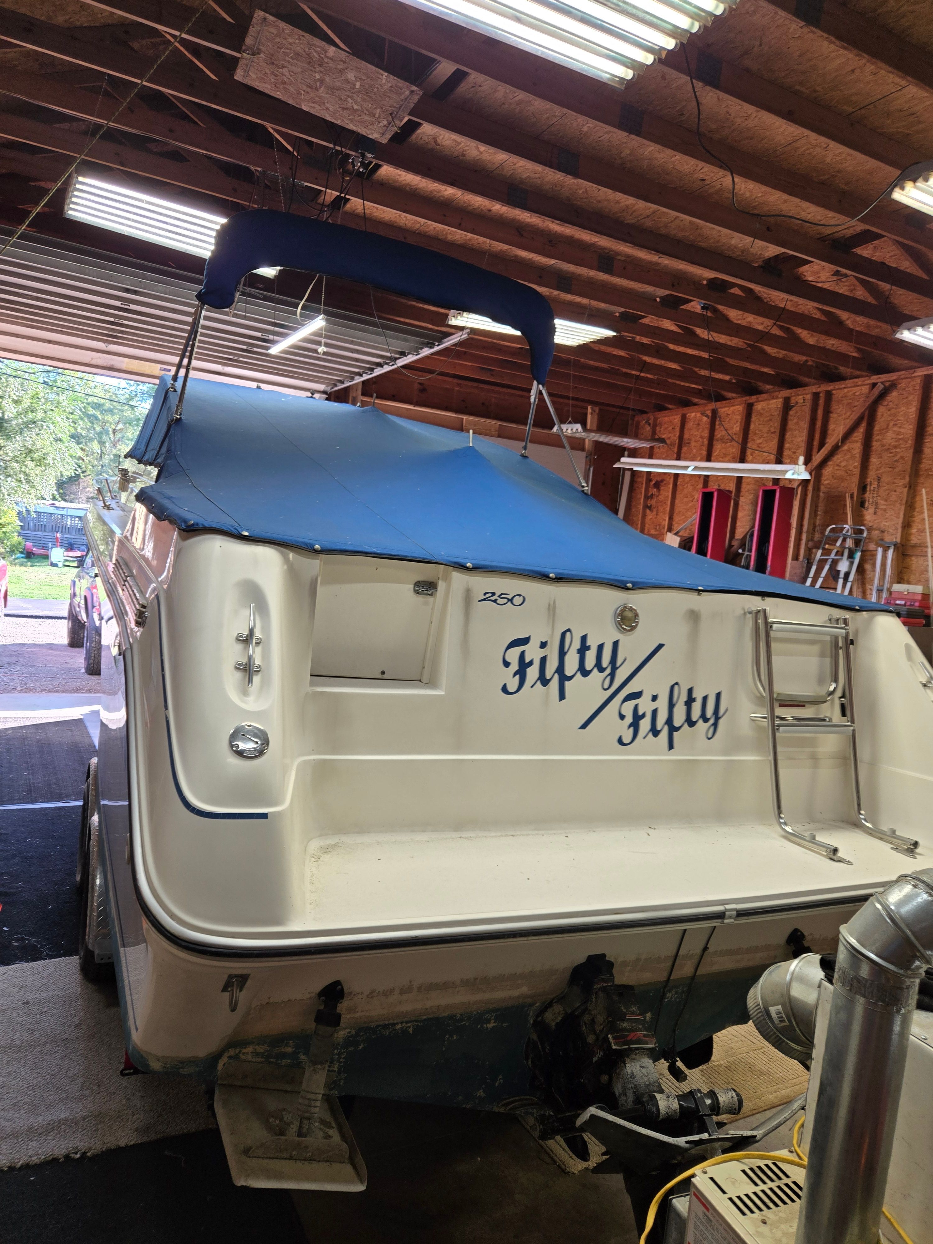 A 1991 Sea Ray 250 Weekender in a garage.