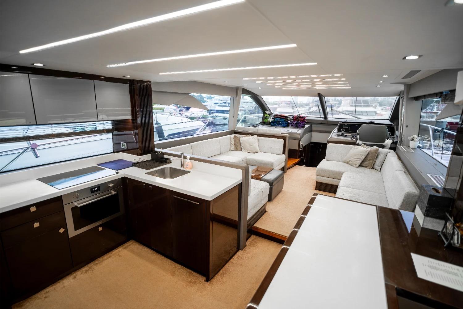 Luxurious interior of 2018 Sunseeker Manhattan 66 yacht with modern kitchen and spacious seating area.