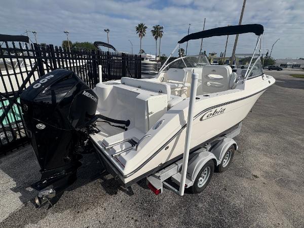 2020 Cobia 220 Dual Console boat on trailer with Mercury outboard engine.