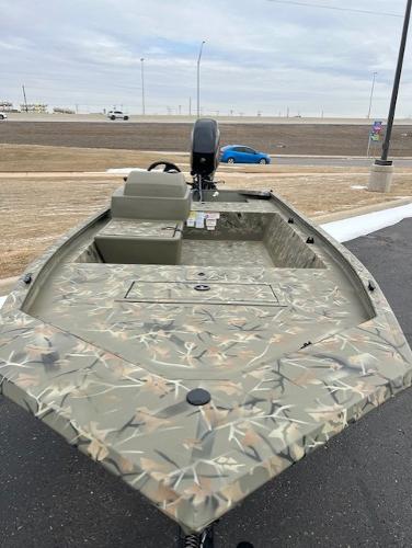 2025 Tracker Grizzly 1648 SC boat with camouflage design, parked outdoors.