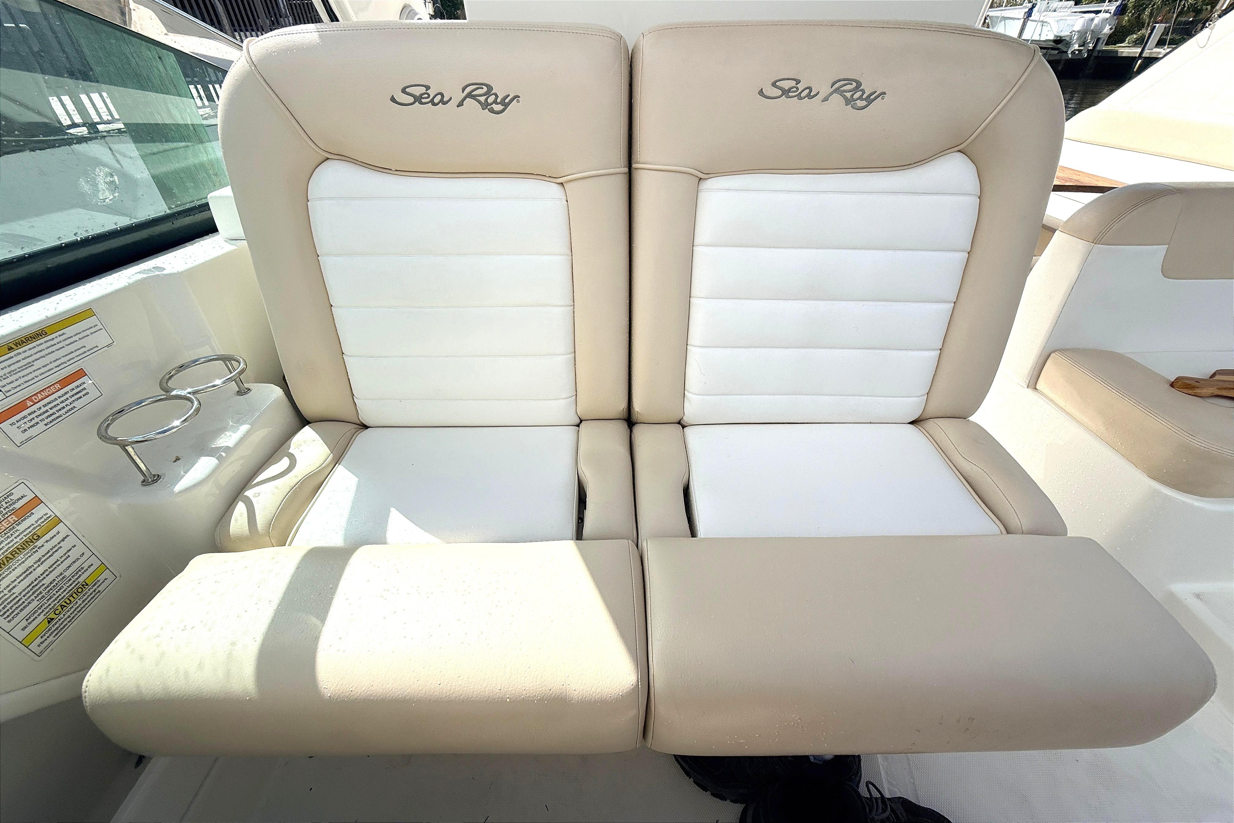 2013 Sea Ray 370 Venture boat seats, beige and white upholstery, with cup holders.