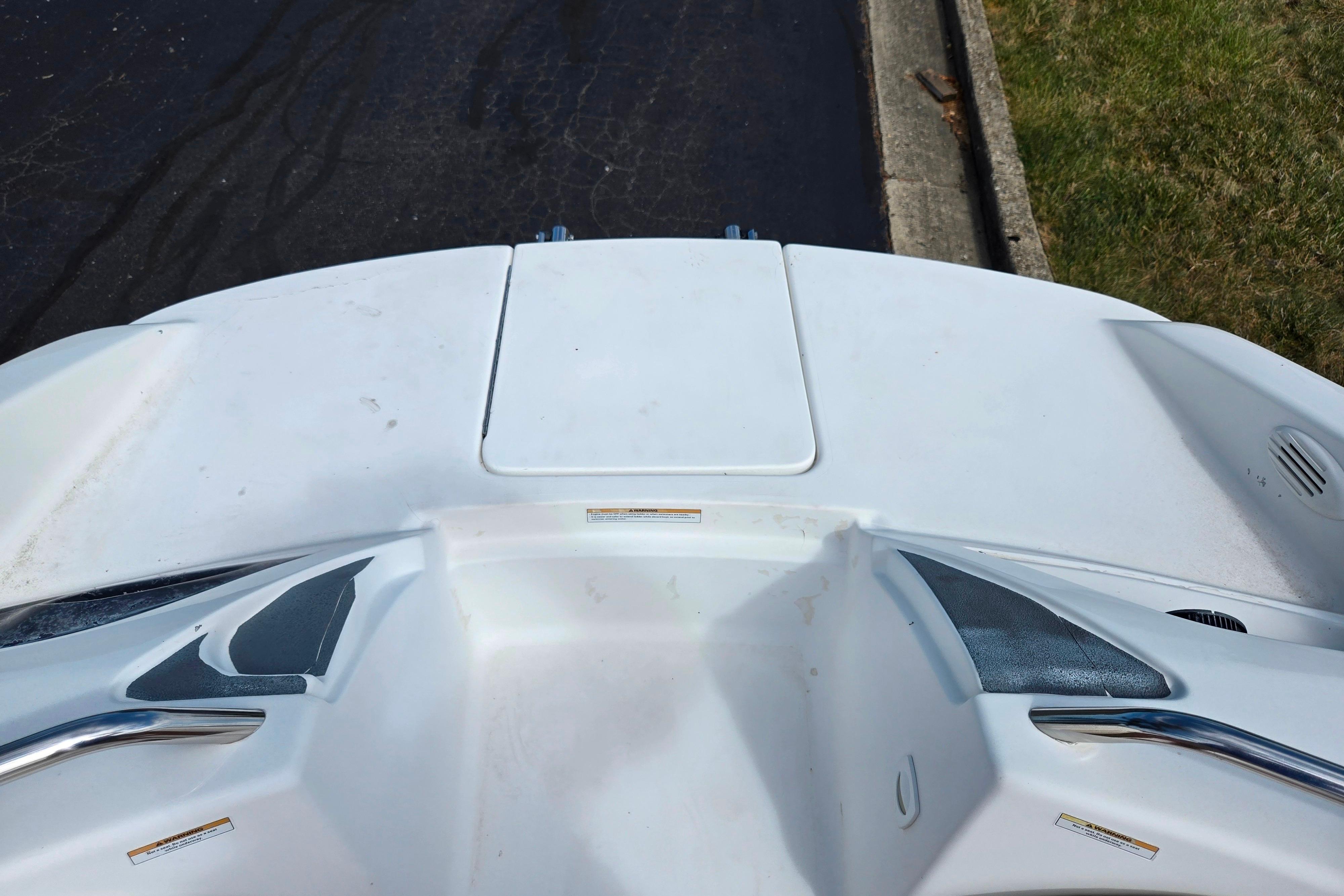 2004 Sea-Doo Islandia boat deck with storage compartment and chrome railings.