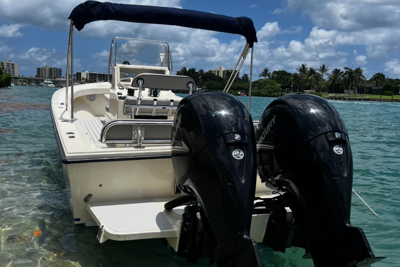 2002 Parker 2500 Special Edition boat with dual engines on clear water.
