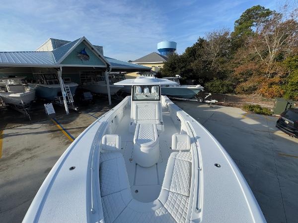 2025 Yellowfin 39 Offshore boat displayed at a dealership, showcasing spacious deck and seating.