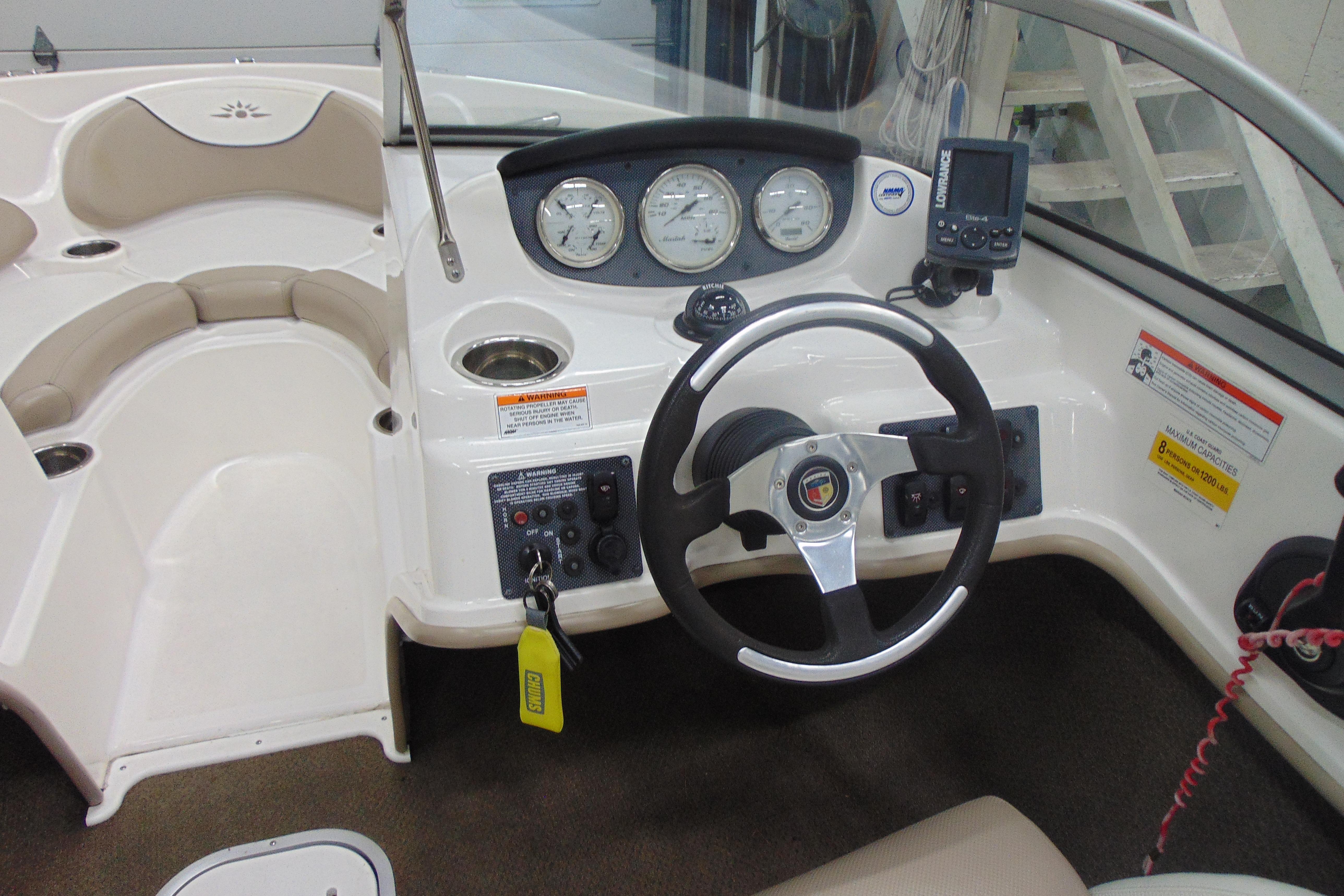 Interior of a 2011 Mariah R18.9 boat featuring steering wheel and dashboard controls.
