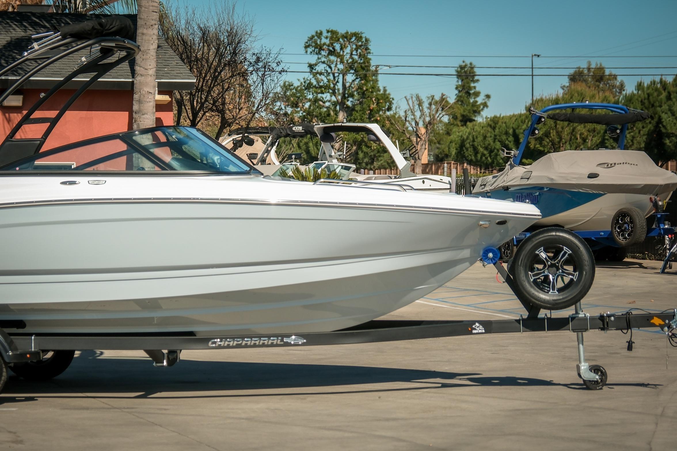 2026 Chaparral 23 SSi boat on trailer in outdoor showroom setting.
