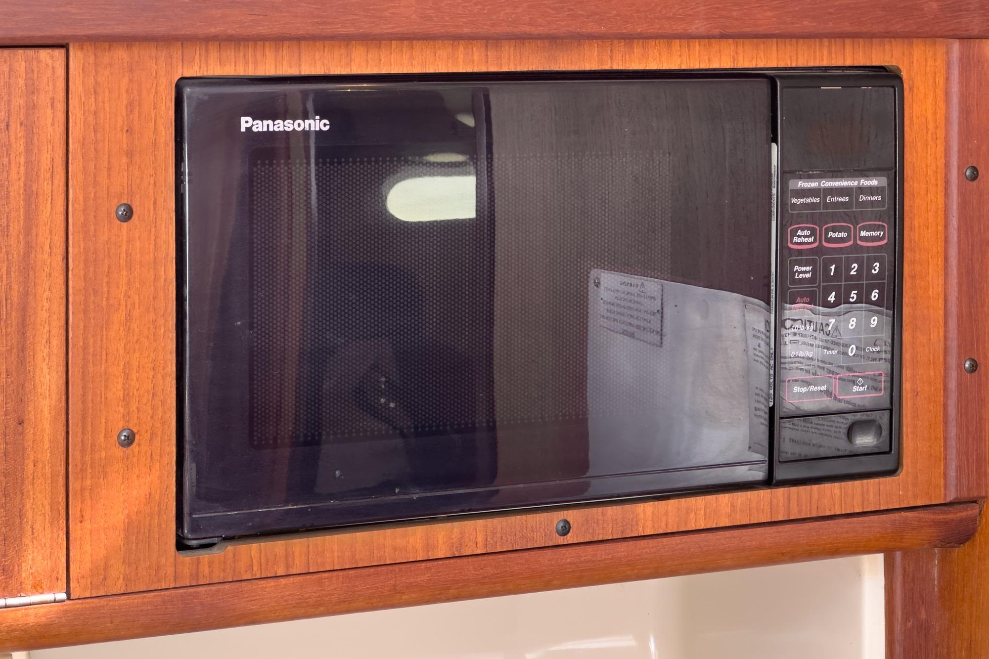 Panasonic microwave in a 1996 Hunter 376 yacht's wooden interior.