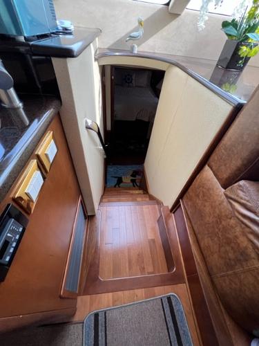 2009 Ovation 52 yacht interior with wooden stairs and modern decor.