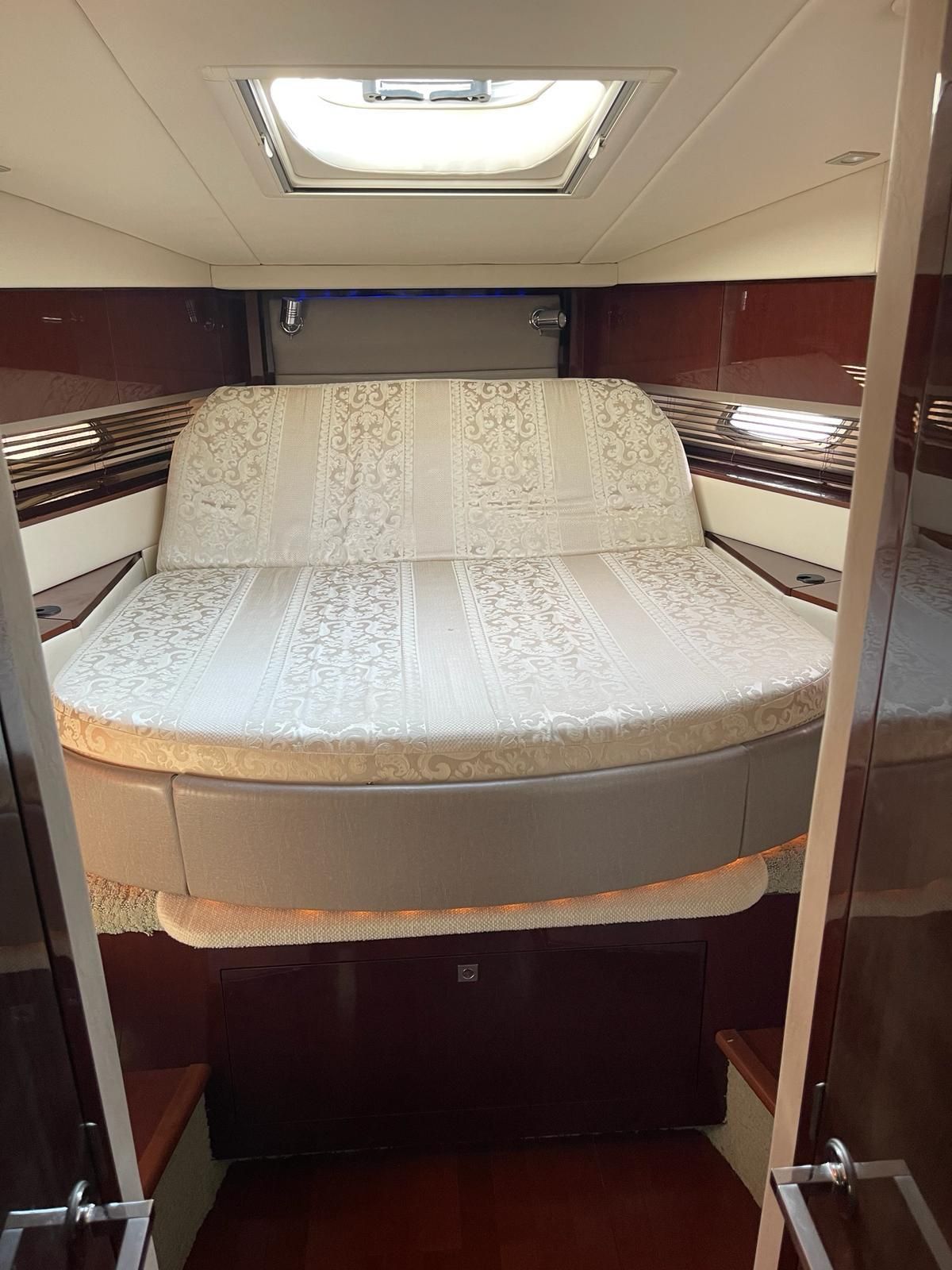 Interior of a 2010 Sea Ray 450 yacht featuring a luxurious bed.