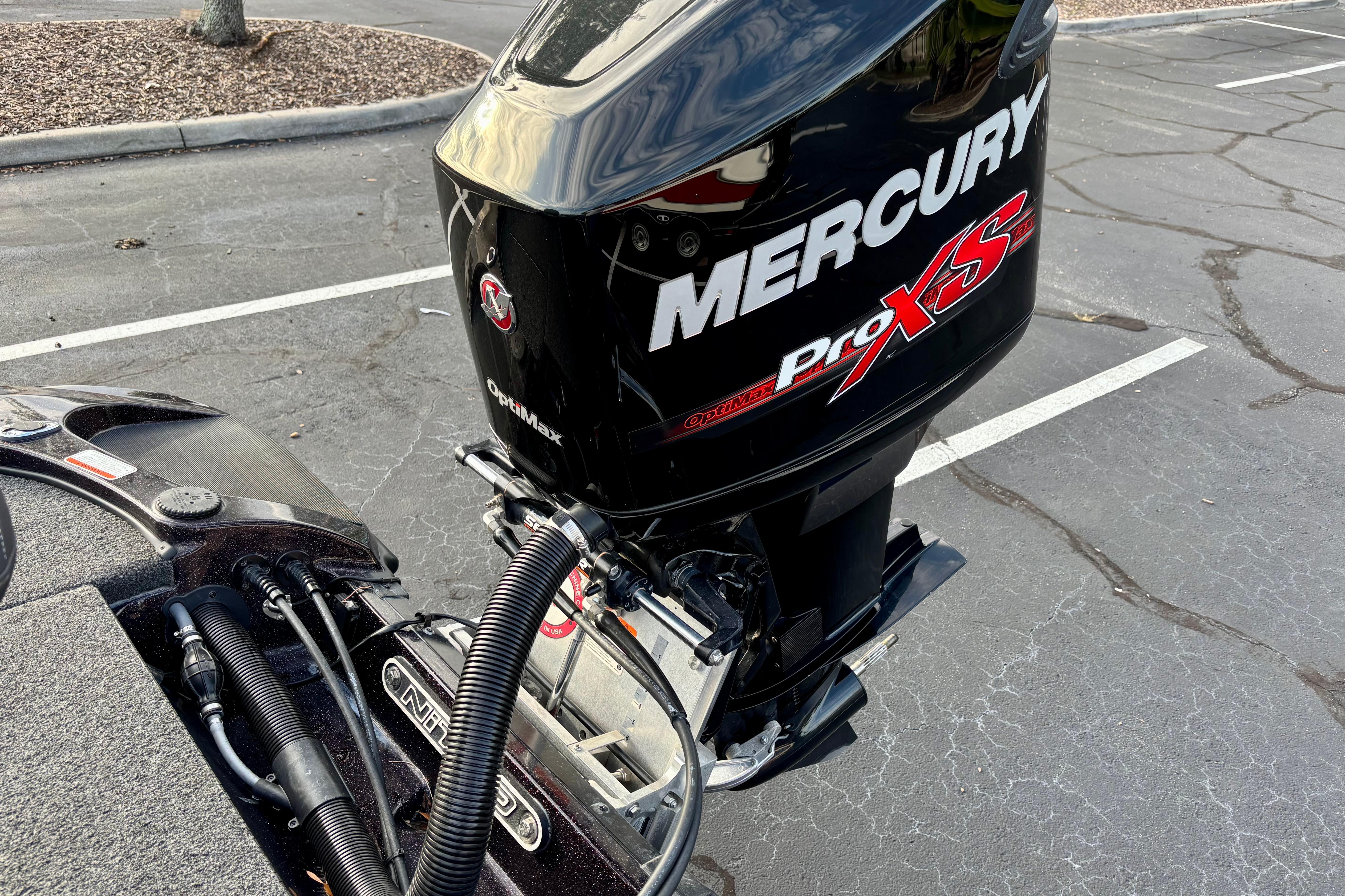 2018 Nitro Z18 boat with Mercury Pro XS outboard motor in parking lot.