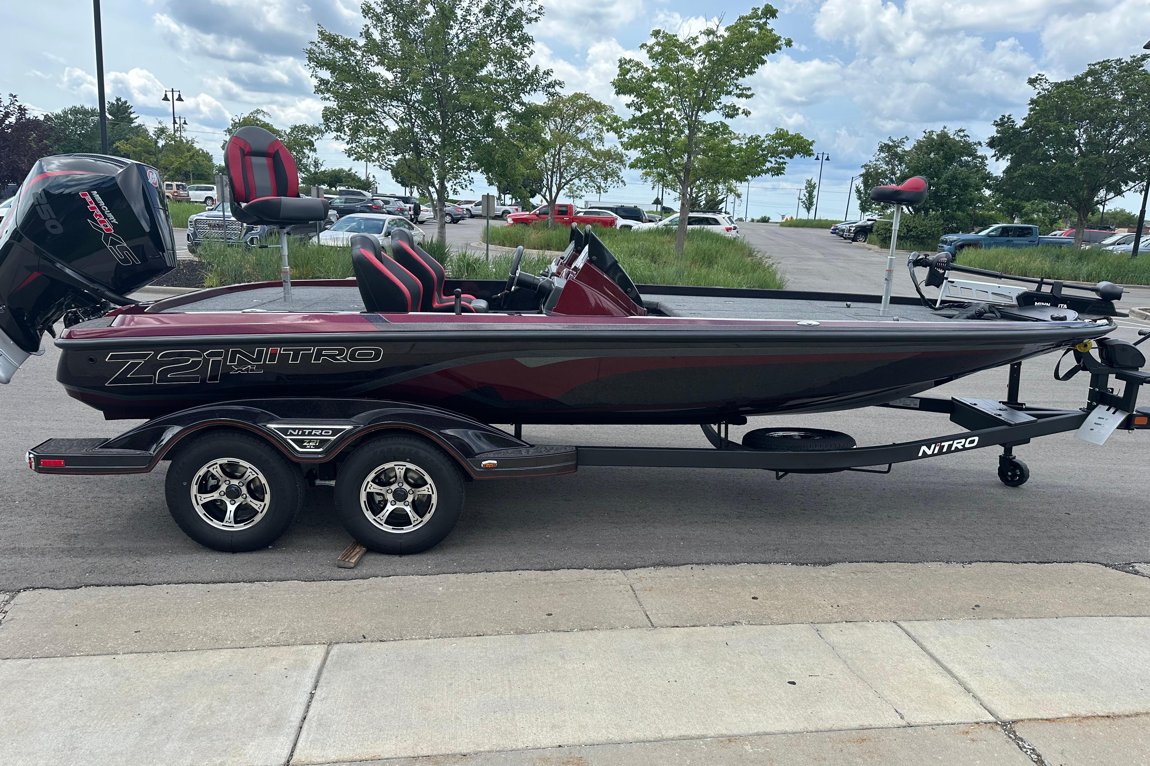 2026 Nitro Z21 XL boat on trailer, parked outdoors under cloudy sky.