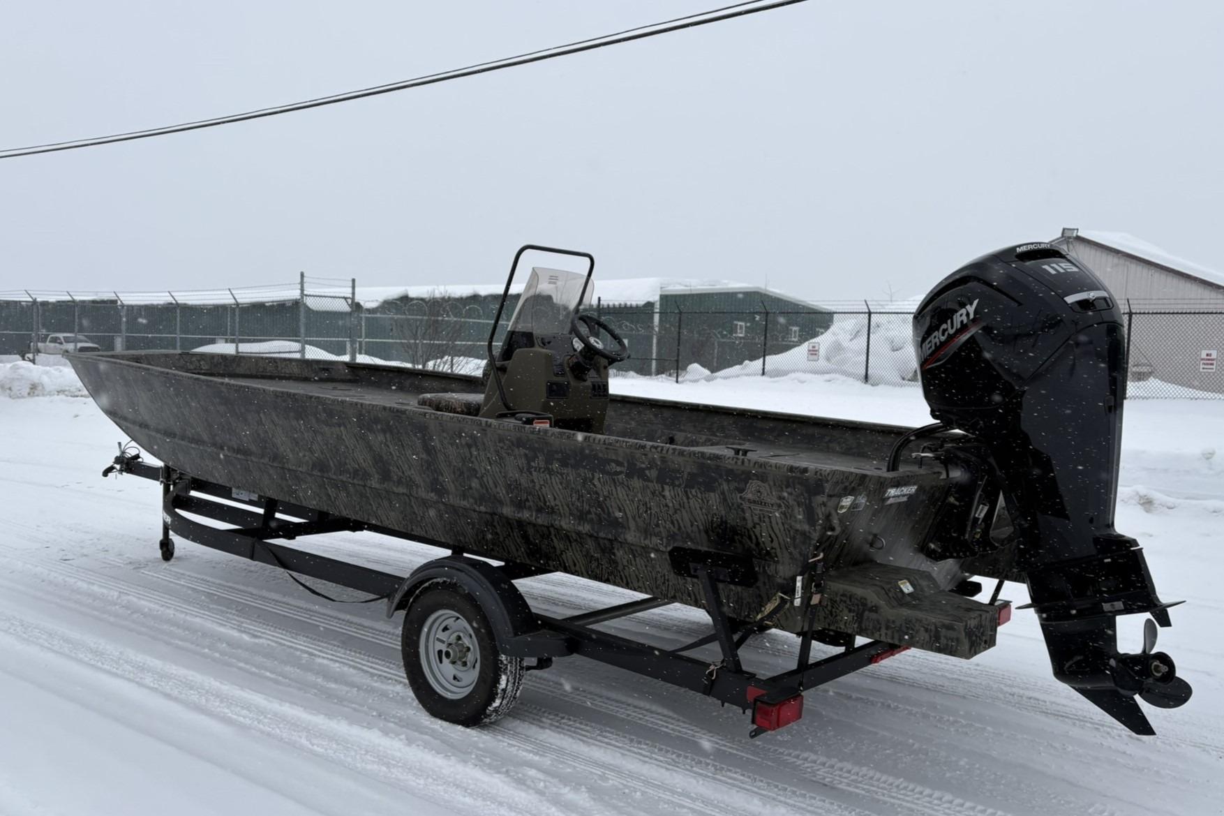 2025 Tracker Grizzly 2072 CC boat on trailer in snowy setting.