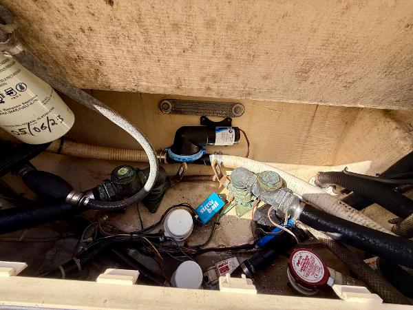 Engine compartment of a 2016 Scout 245 Dorado boat showing hoses and components.