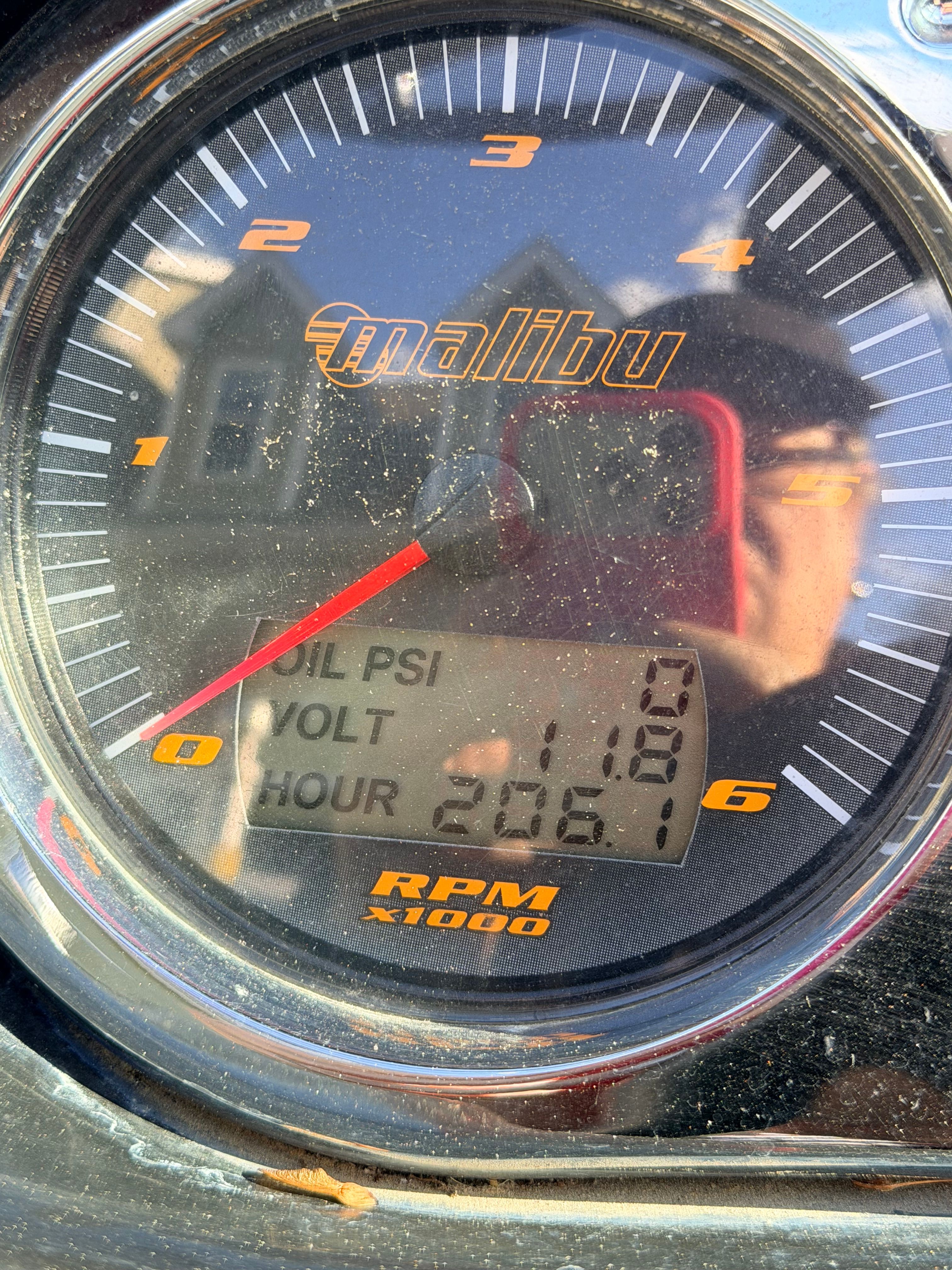 Malibu iRide 2006 tachometer displaying oil PSI, voltage, and hours.