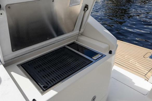 Outdoor grill on 2022 Tiara Sport 43 LE boat, near water.