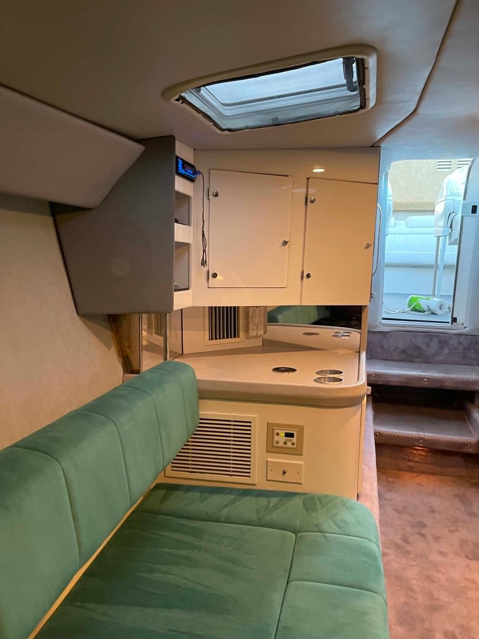 Interior of a 2000 Formula 419 Fast Tech with green upholstery and storage space.