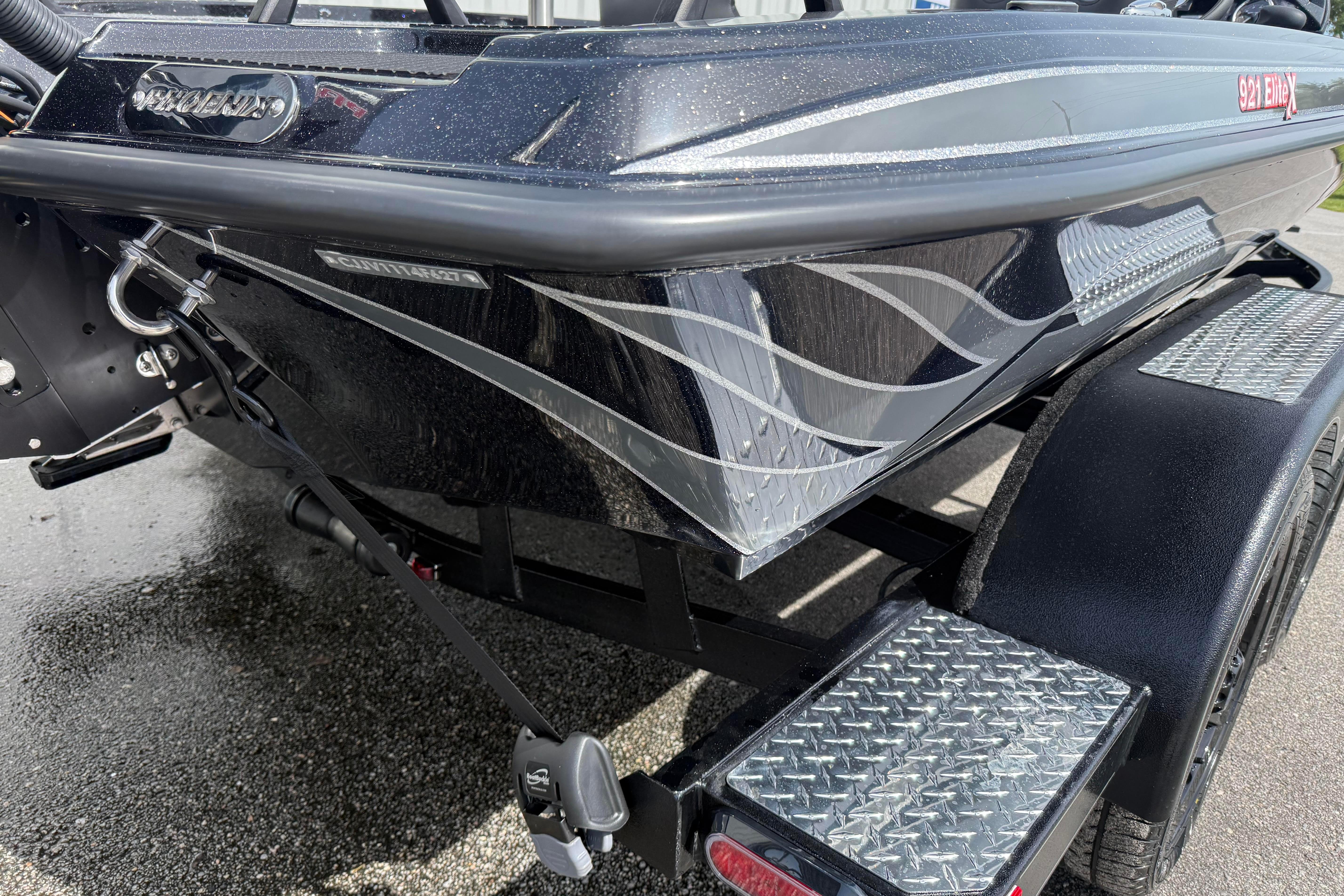 2027 Phoenix 921 Elite X boat on trailer, showcasing sleek design and metallic accents.