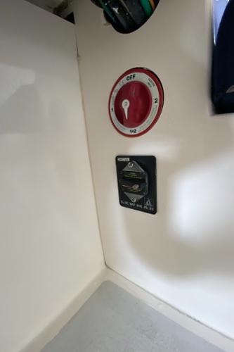 Close-up of a switch and dial on a boat's interior.