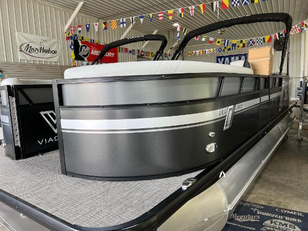 2023 Viaggio Lago 22U Tri Toon with Mercury 150 engine displayed in a showroom.