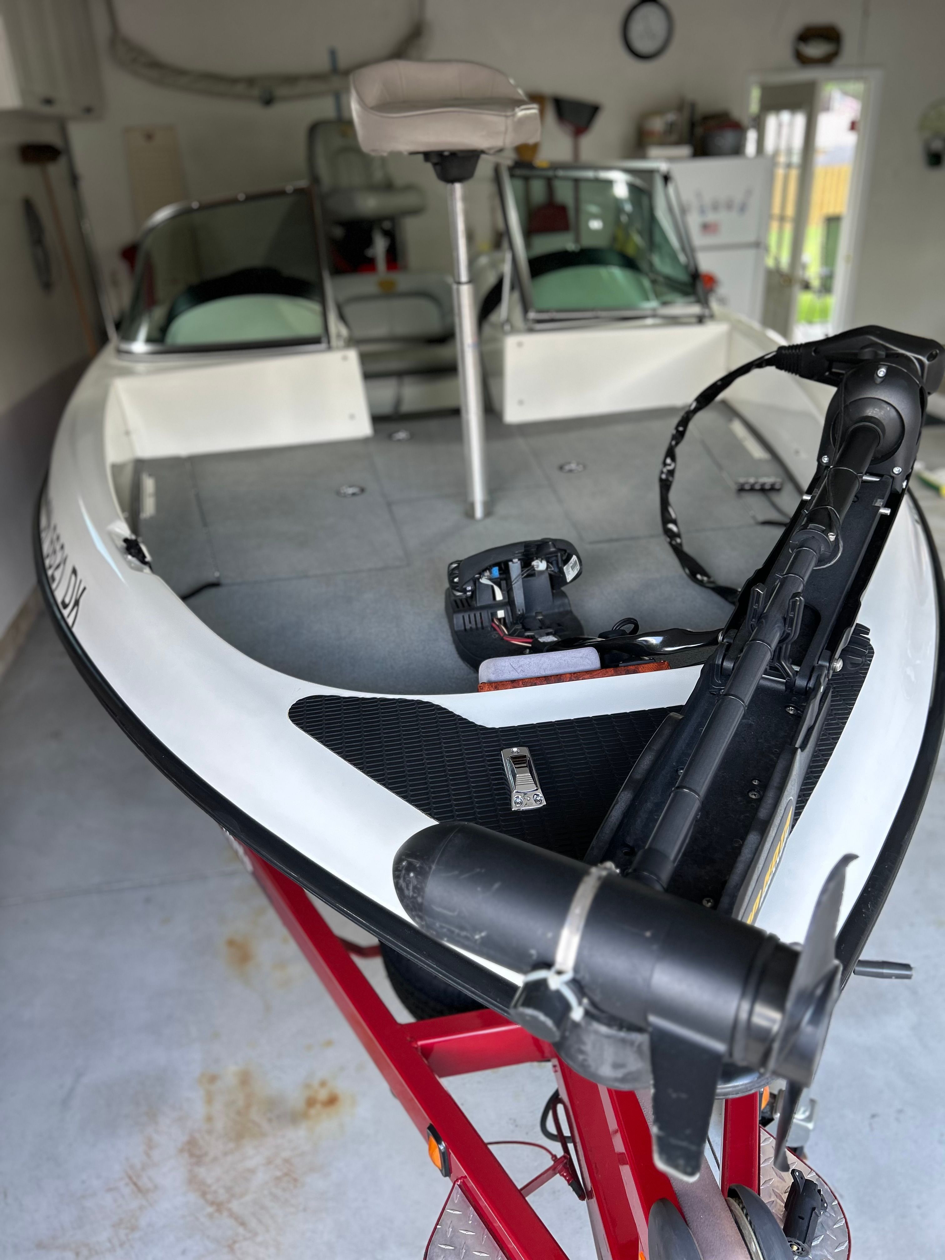 A 2003 Triton 190FS boat is on a trailer in a garage.