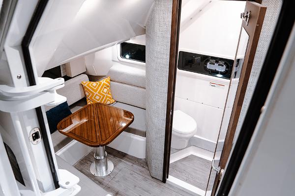 Manufacturer Provided Image: 2025 Everglades 455 Center Console cabin interior with table and seating.