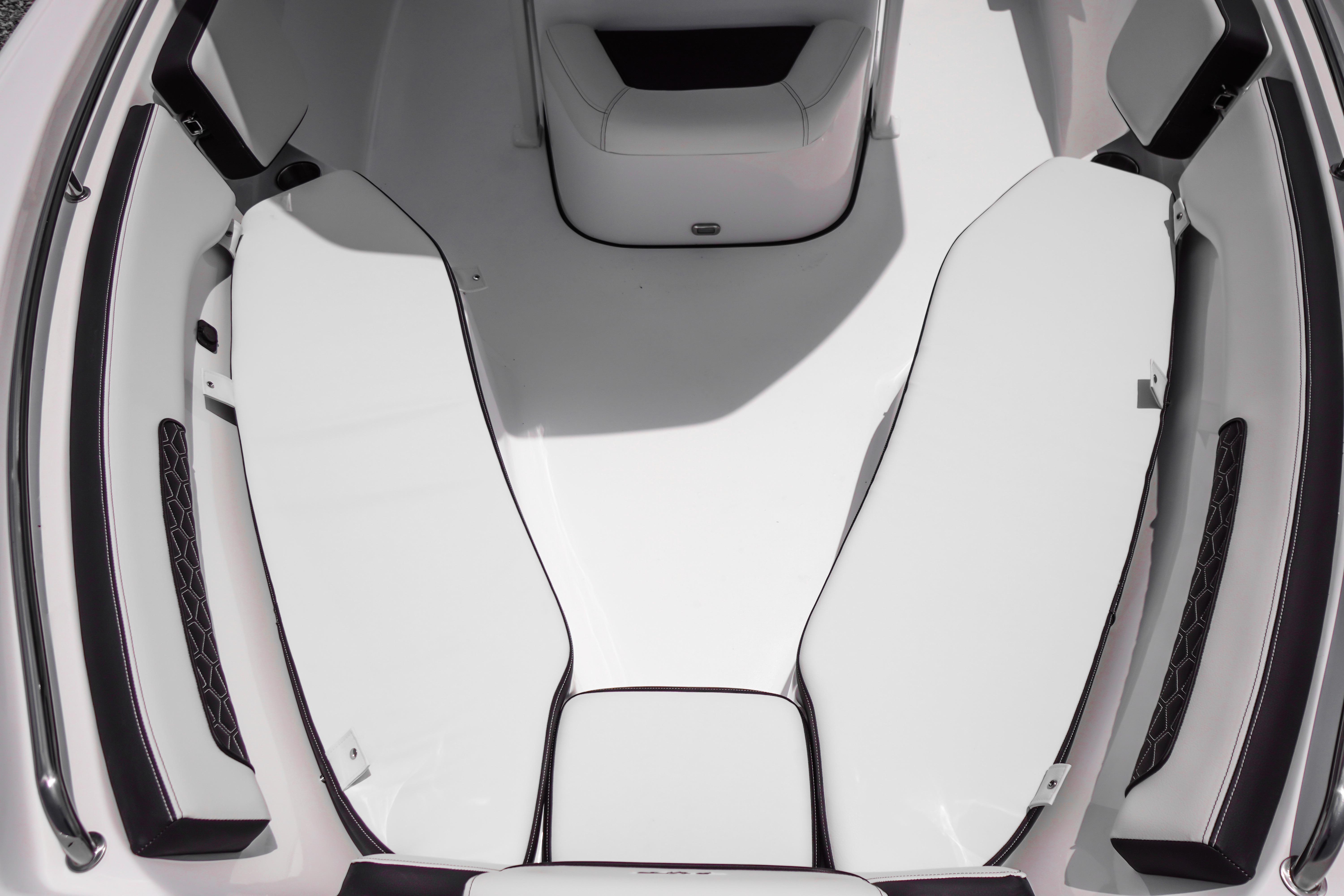 Interior seating of 2027 Tidewater 220 CC Adventure boat, featuring sleek white cushions.