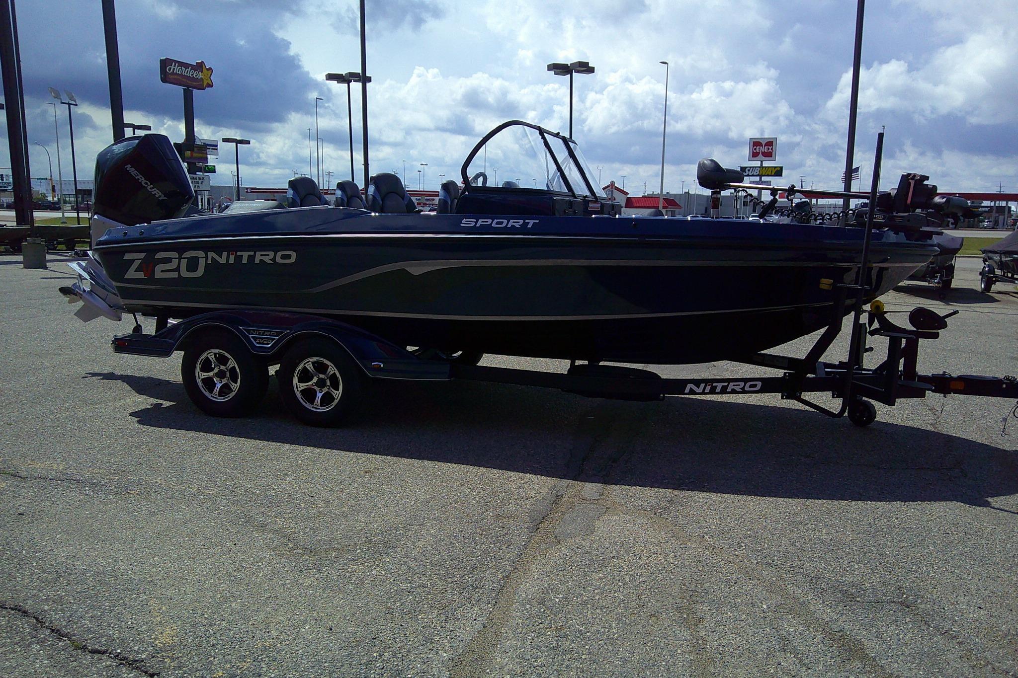2025 Nitro ZV20 Sport boat on trailer in parking lot under cloudy sky.