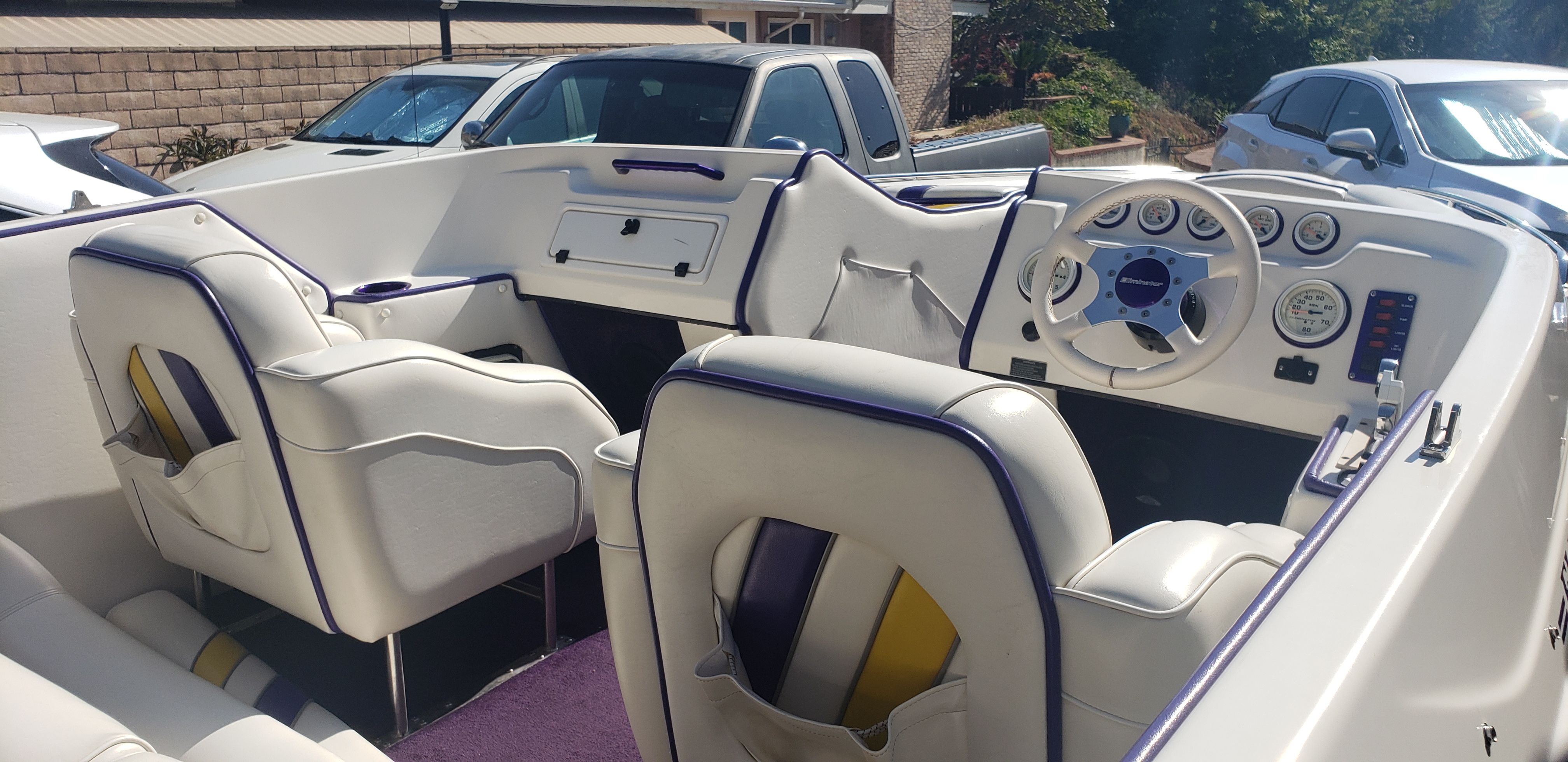 Interior of a 1999 Eliminator 220 Eagle XP boat with purple accents.