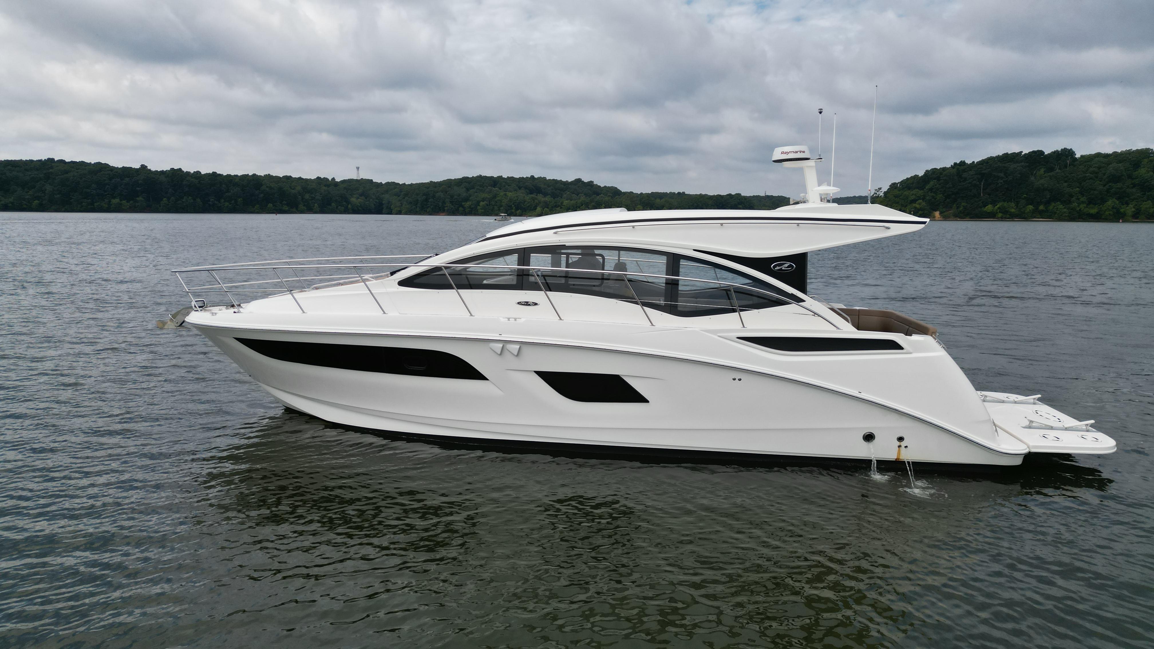 2017 Sea Ray Sundancer 400 yacht on a calm lake under cloudy skies.