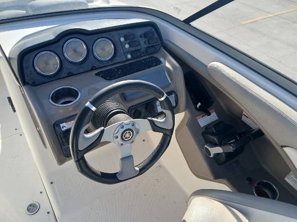2010 Yamaha Boats 242 Limited dashboard with steering wheel and gauges.