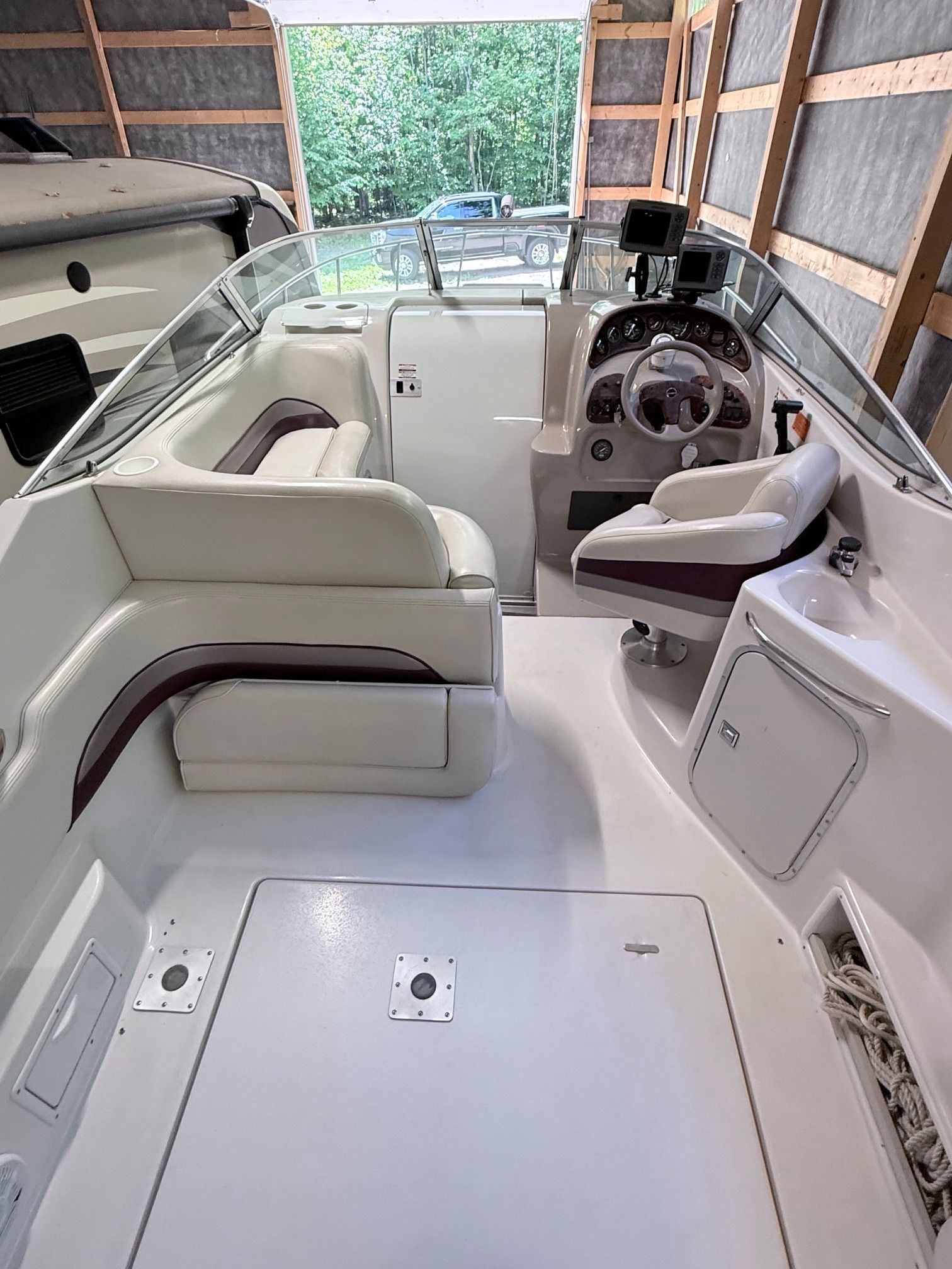 The image shows the cockpit of a 1997 Chaparral Signature 260 with white seating and helm console.