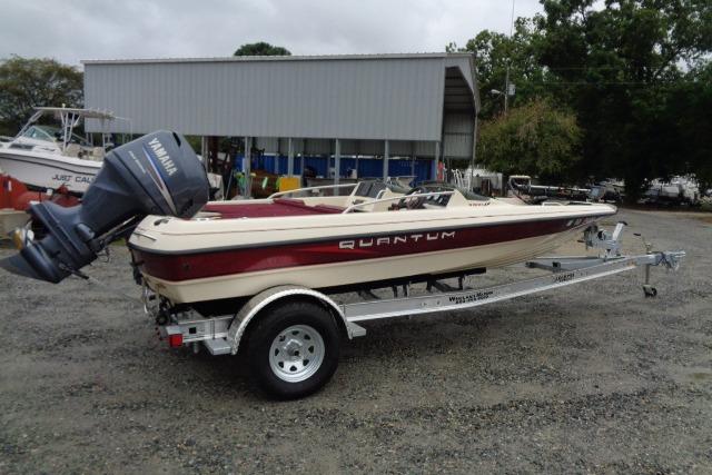 1996 Quantum 180 XD boat on trailer with Yamaha outboard motor, parked outdoors.