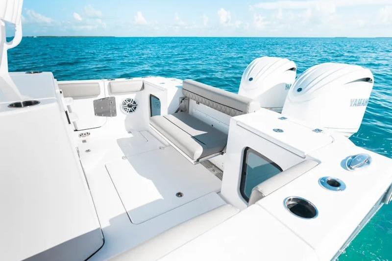 2026 Sportsman Open 282 Center Console boat on clear blue water, featuring dual engines.