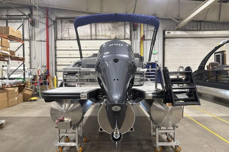 2026 Bennington 23 LXS Swingback pontoon boat in a warehouse setting.