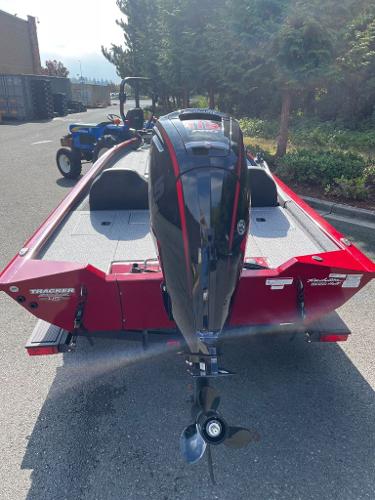 2023 Tracker Pro Team 190 TX boat with outboard motor, parked outdoors.