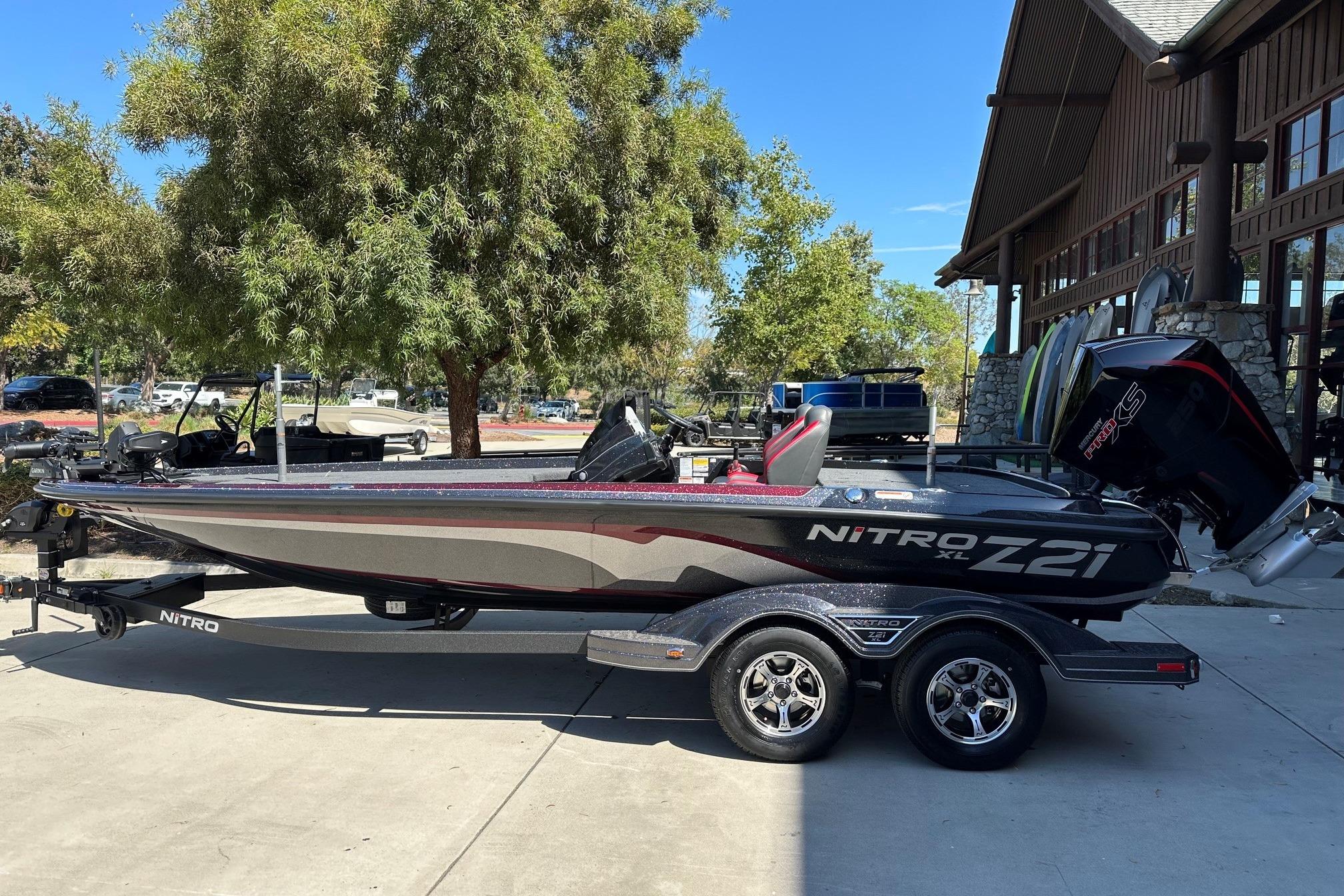 2026 Nitro Z21 XL Pro boat on trailer, parked outdoors near a building.