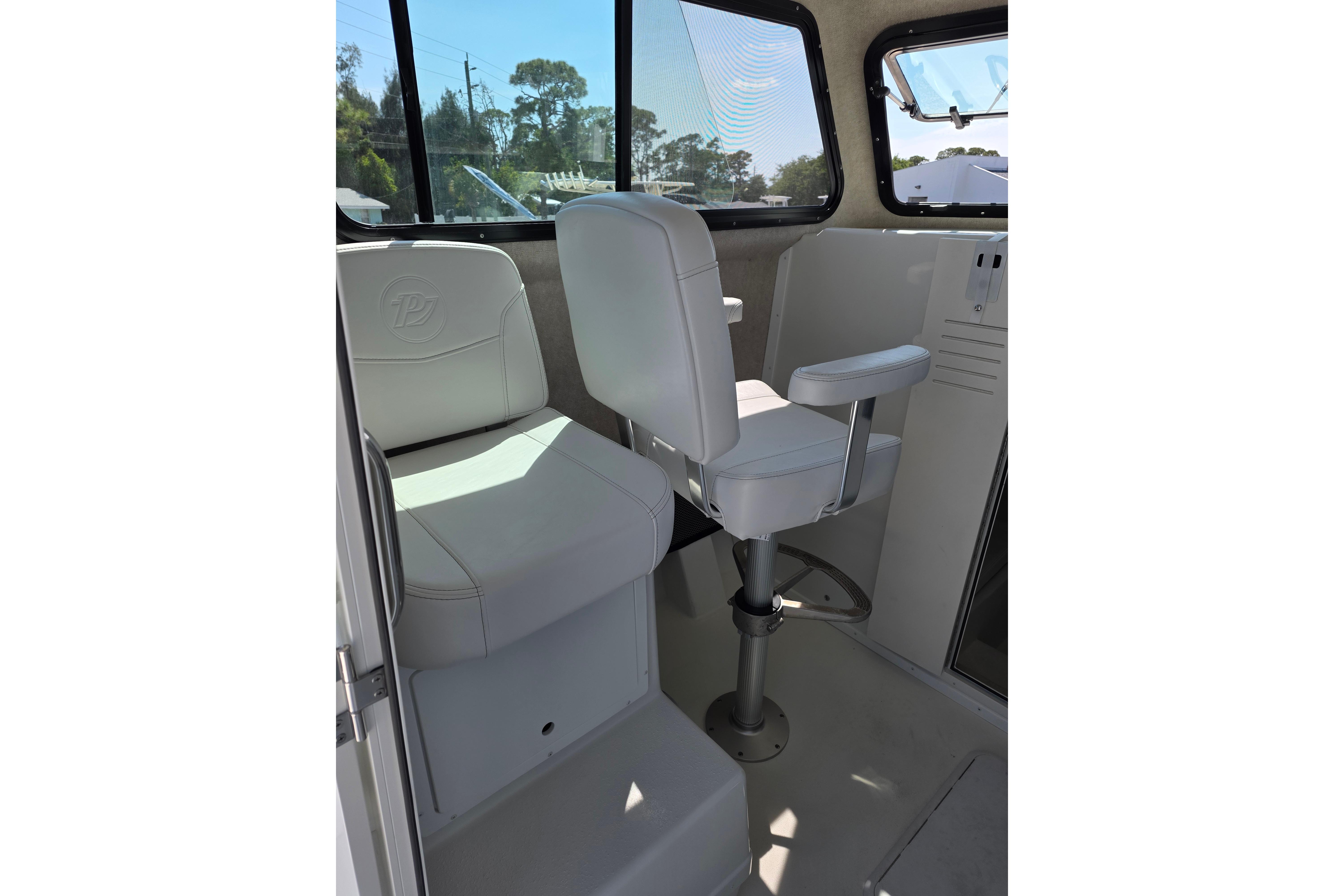 Interior seating of 2026 Parker 287 Explorer boat with white cushioned chair.