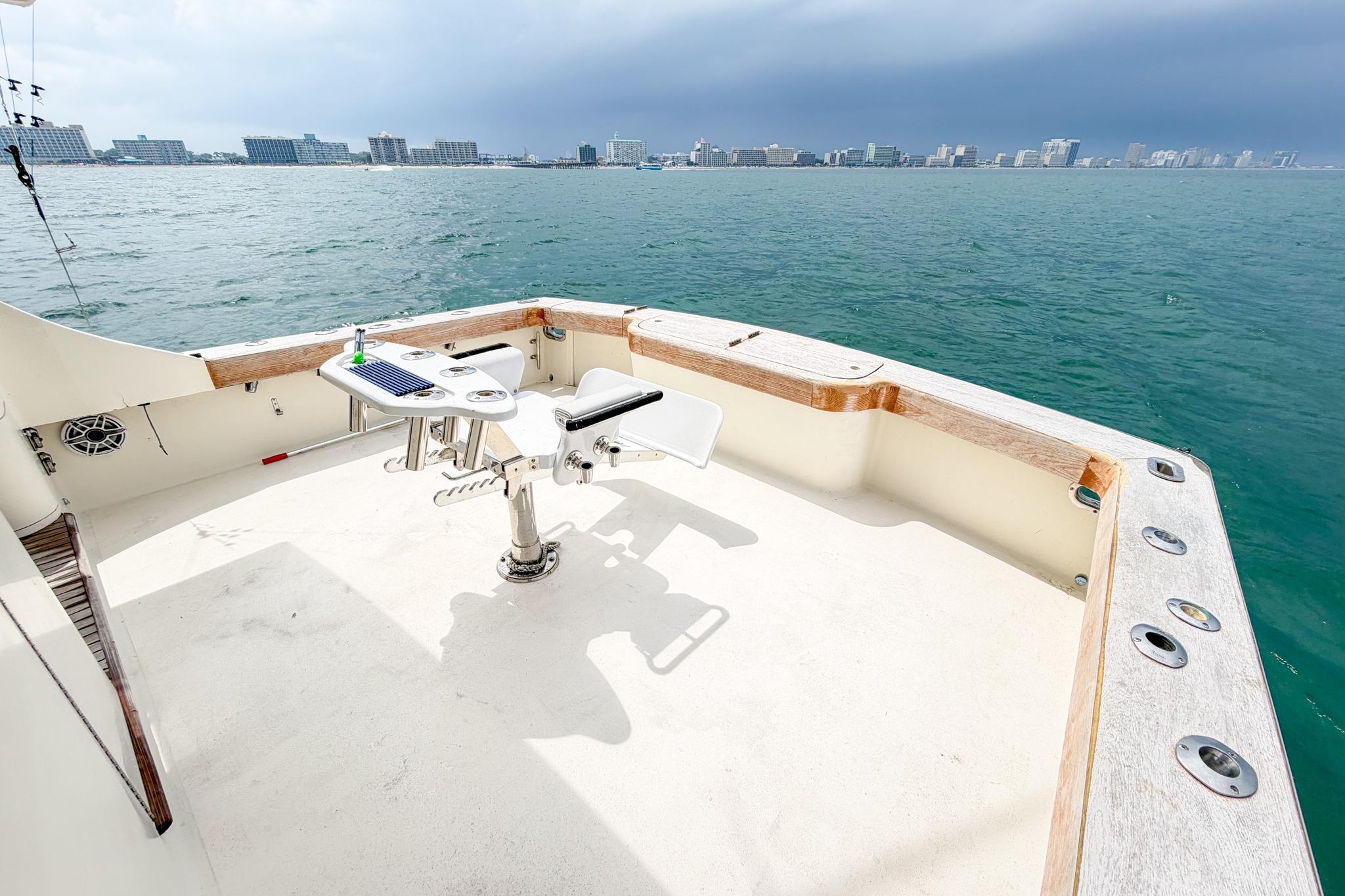 1998 Blackwell Custom Carolina Sportfish boat deck with fishing chair, overlooking city skyline.